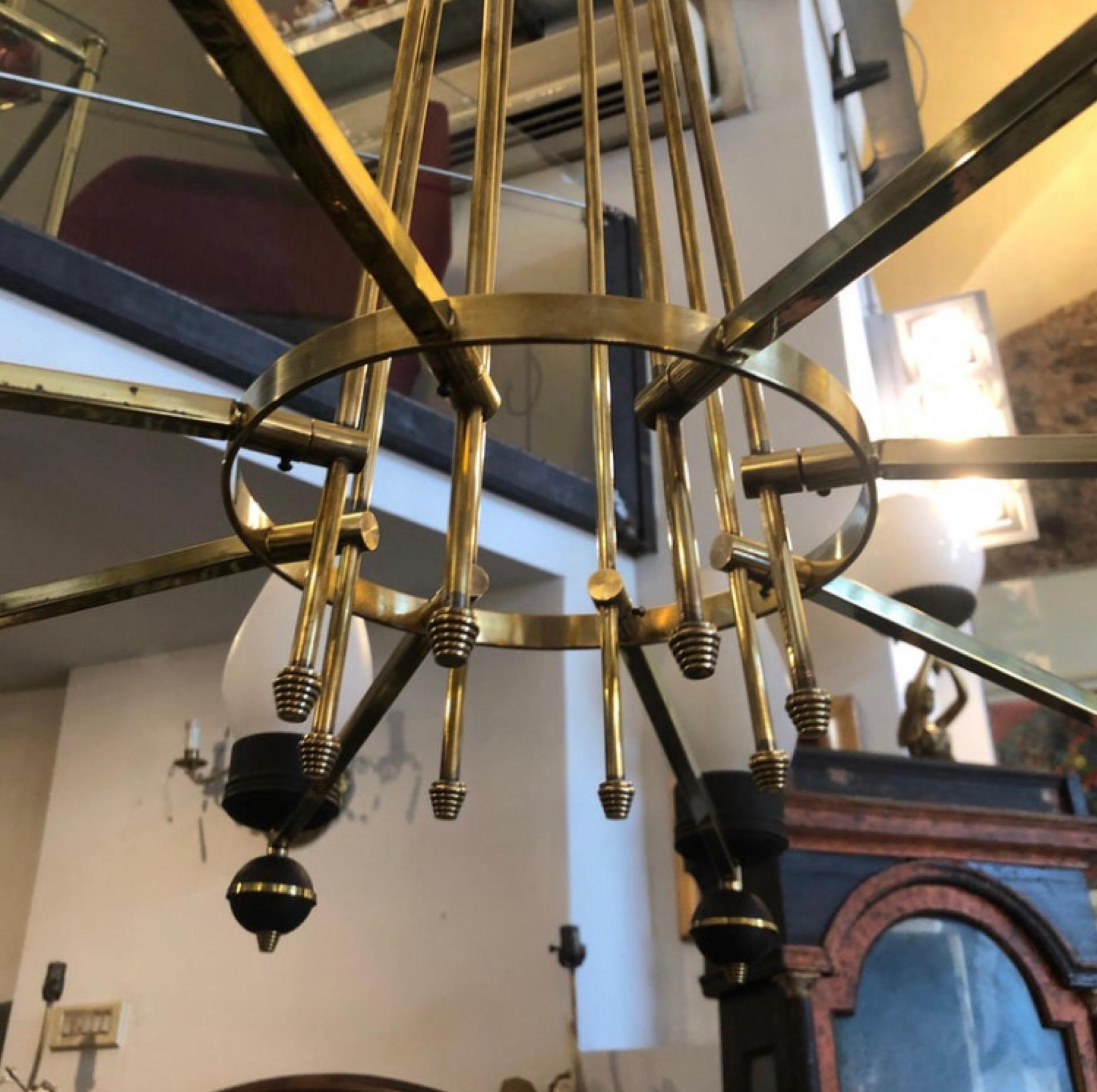 Stylish Mid-Century Modern chandelier made in Italy in the 1950s. It's fully restored and rewired, need 8 regular e14 bulbs and works 110-240 volts, the white opaline glass diffusors are in perfect condition. The brass maintain a superb vintage