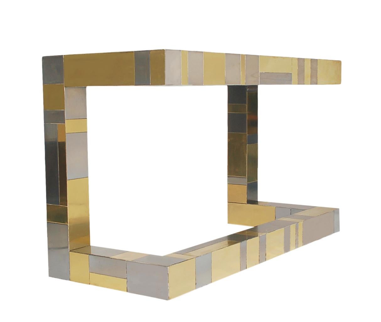 A stunning mixed metal patchwork design made by Paul Evans for Directional Furniture. This cantilevered design features brass and chrome panels and two drawers. Good overall condition, with minor scratching and small dimple dings.