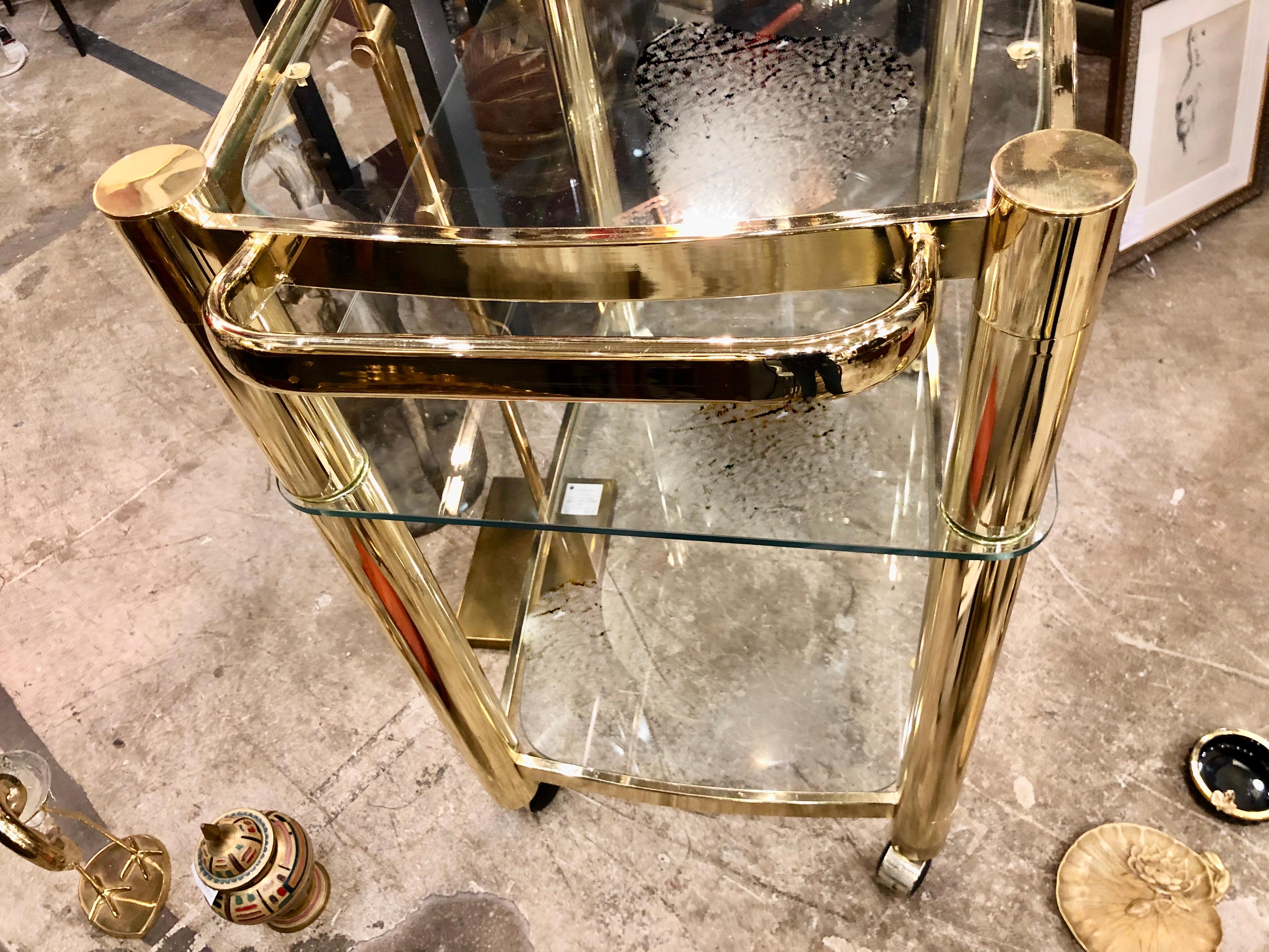 Mid-Century Modern brass and glass bar cart in the style of Pierre Cardin / Karl Springer.
