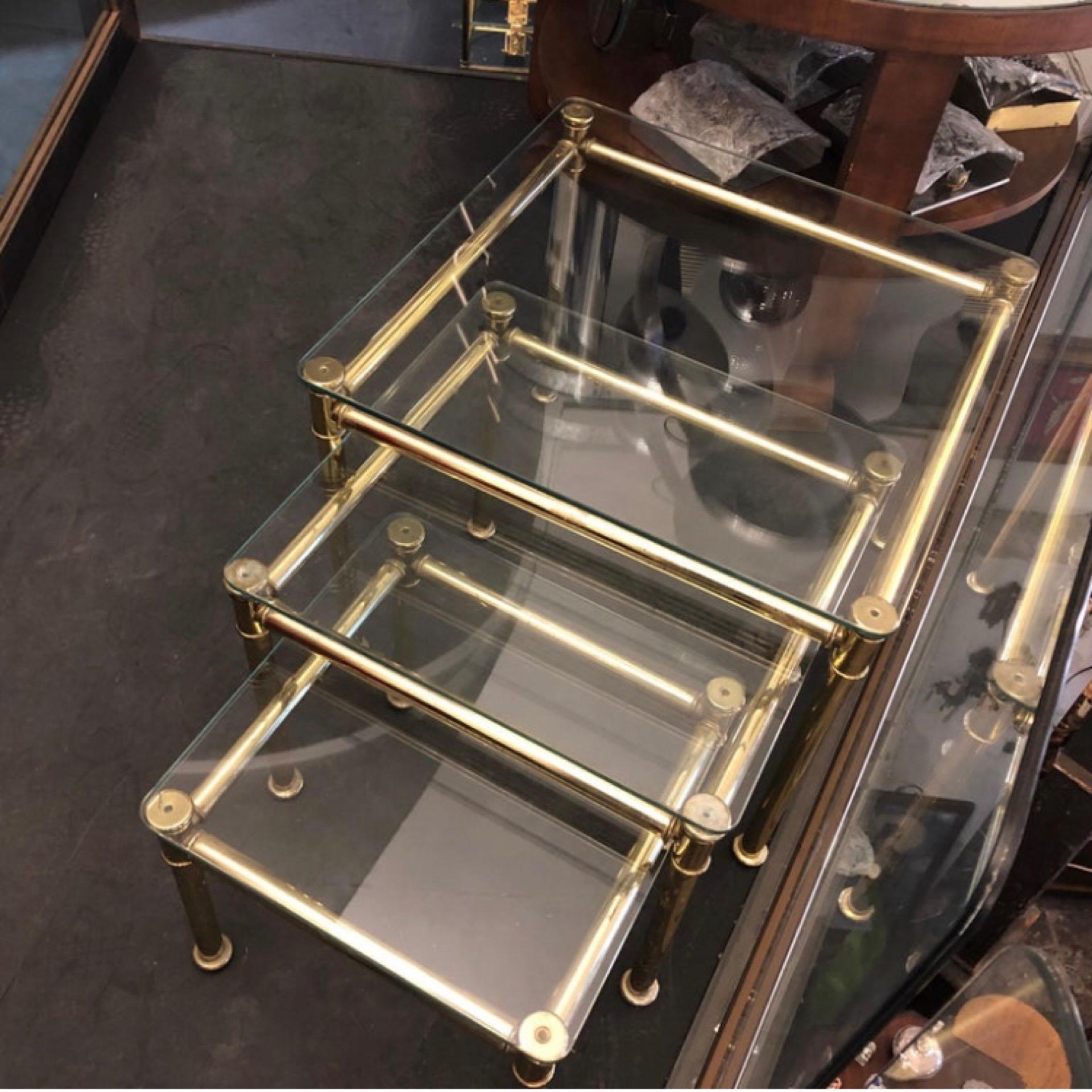 Three brass and glass nesting tables in the manner of Tommaso Barbi designed and manufactured in Italy in the 1960s. Good conditions overall. The 1960s was a significant period for Mid-Century Modern design, characterized by clean lines, geometric