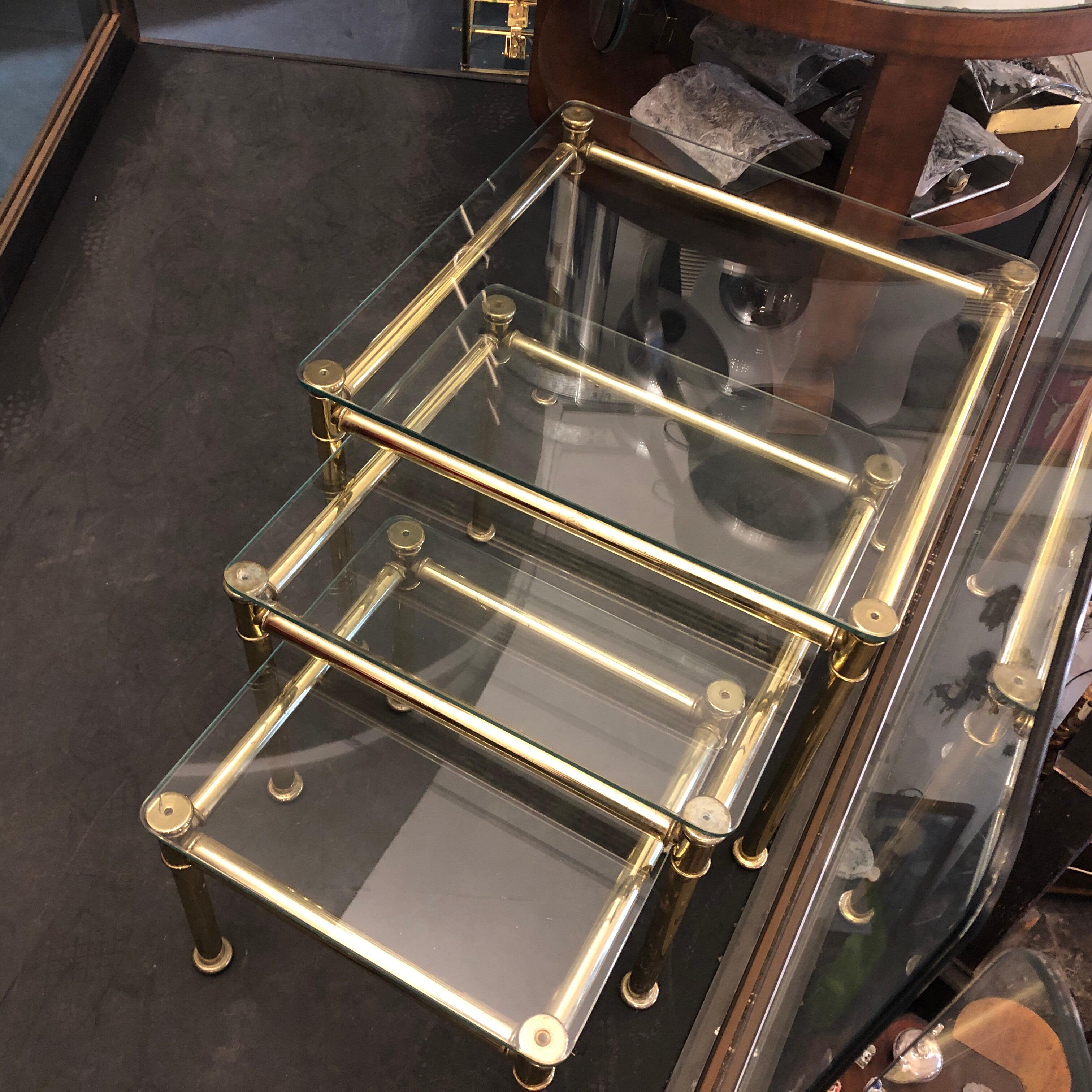 Three brass and glass nesting tables in the manner of Tommaso Barbi, made in Italy in the 1960s. Good conditions overall.