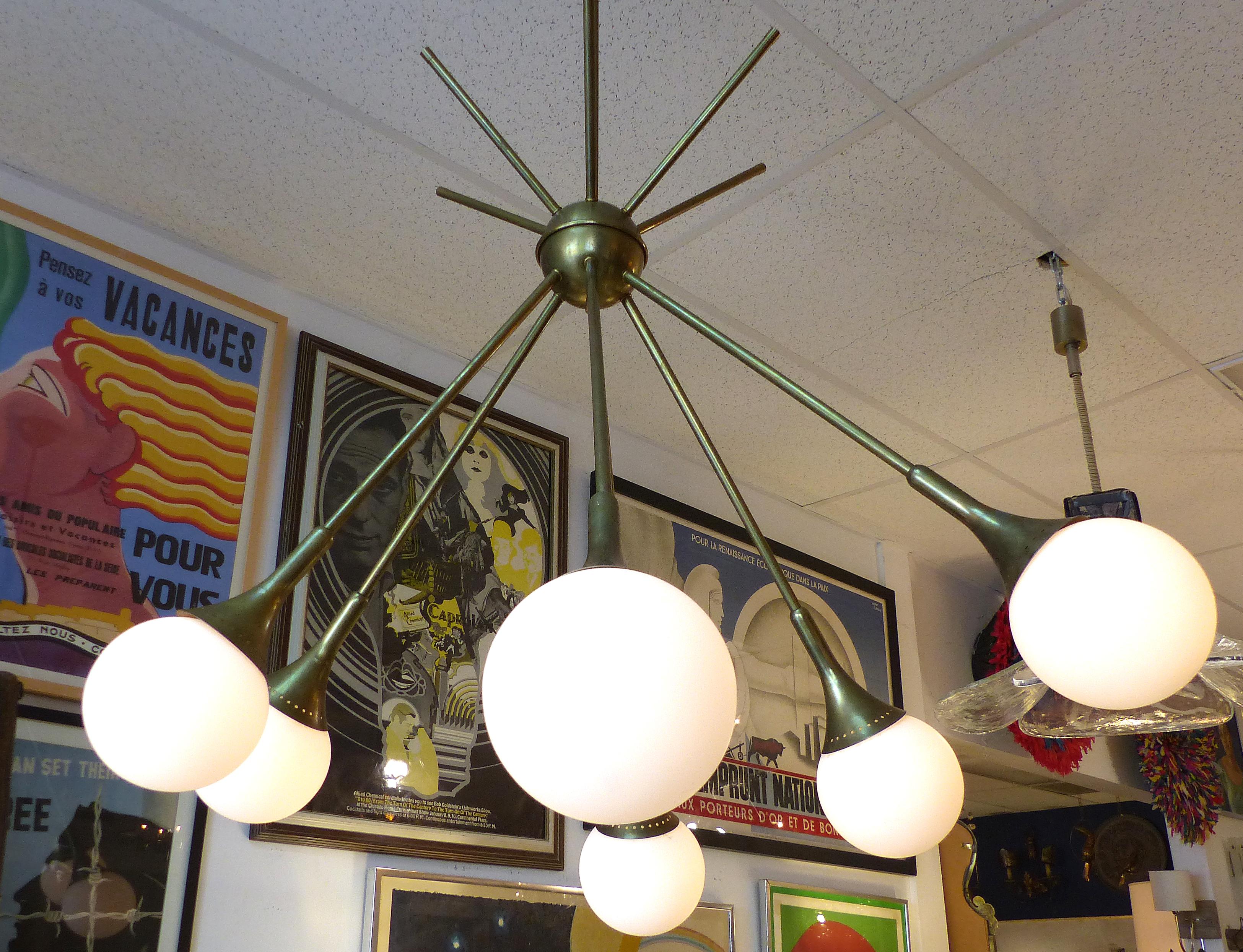 Mid-Century Modern Brass and Glass Sputnik Chandelier

Offered for sale is a Mid-Century Modern brass and glass globe six-light Sputnik style chandelier. The frosted white globes are irregularly positioned to create a light feeling with movement.