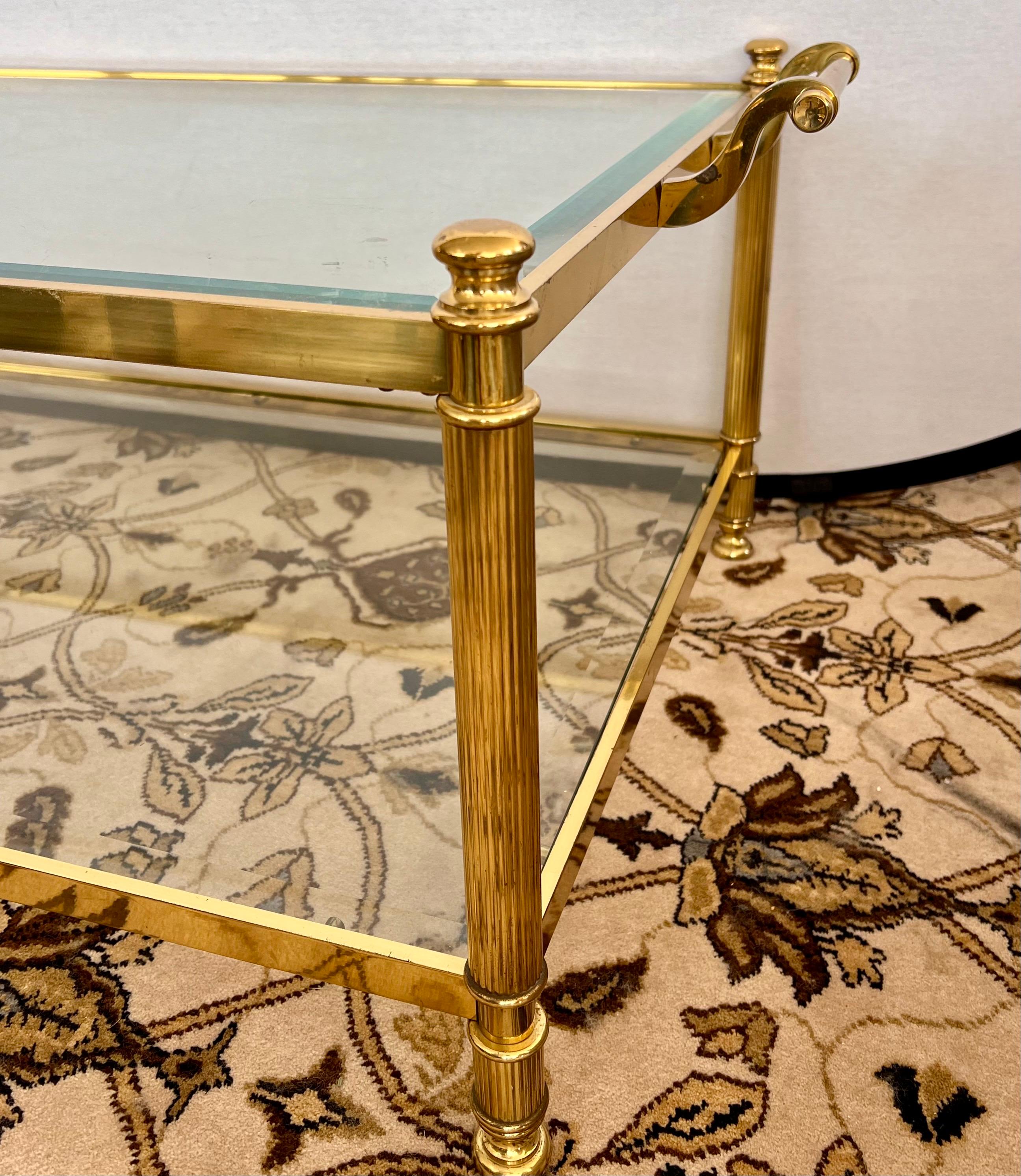 Two tiered brass and glass cocktail table with handles on each side.
Ideal for a modern or transitional aesthetic but quite honestly would pair well
with any luxury residence.  Why not own the best?