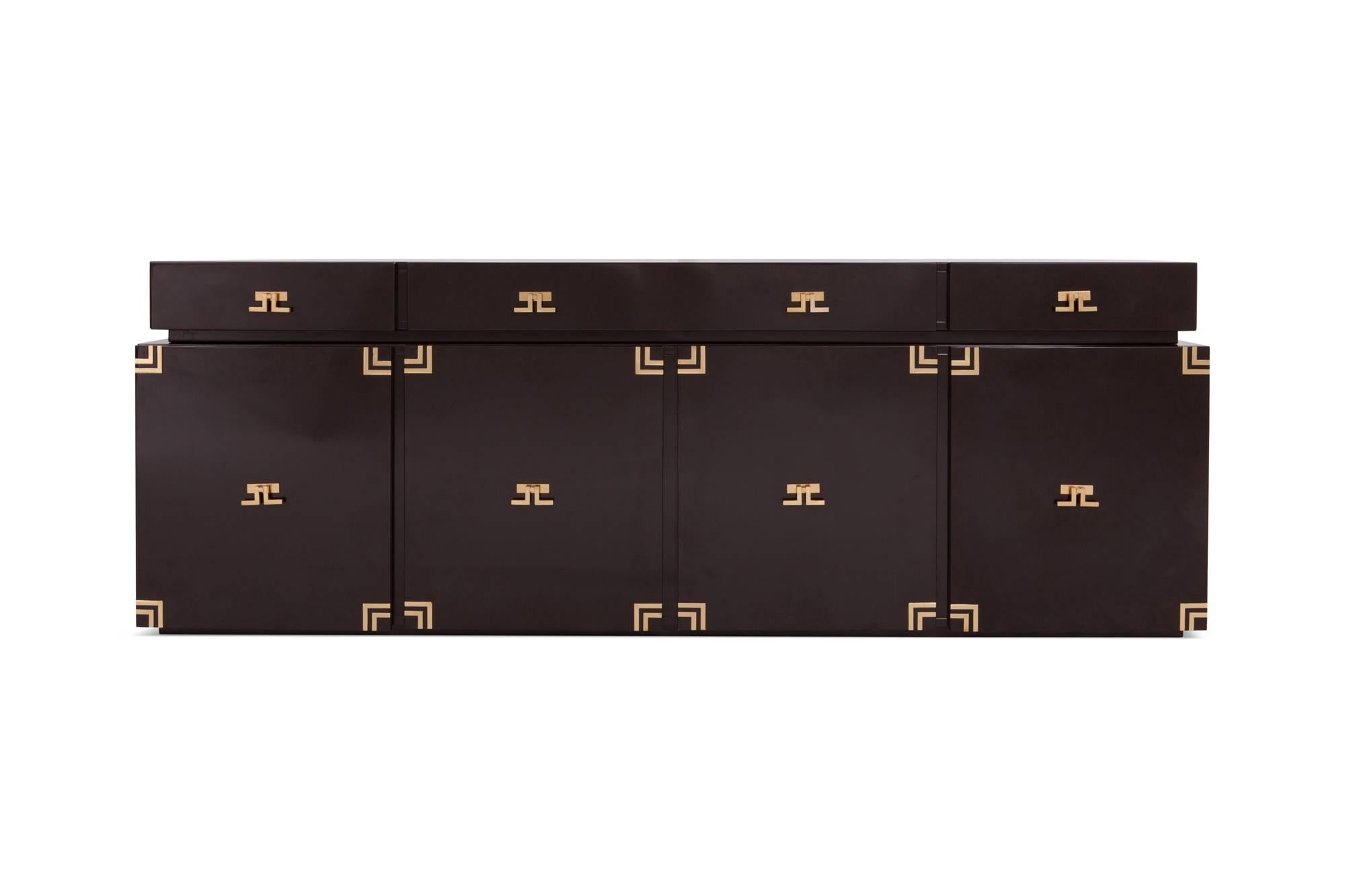 Hollywood Regency dark brown lacquered sideboard in the style of Maison Jansen, France, 1960s

The cabinet provides plenty of storage space due to it’s large cabinets and three drawers on the floating top.

All are finished with stunning brass