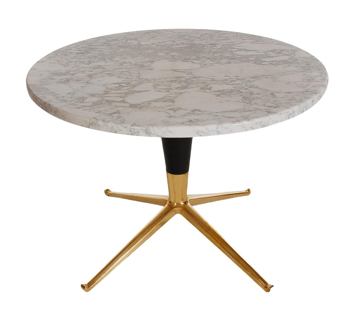 A chic circular side table from the 1950s in the style of Ico Parisi or Paul McCobb. The table features a brass pedestal base, black wood conical shaft, and thick round marble top. Nice, clean, and ready for immediate use.