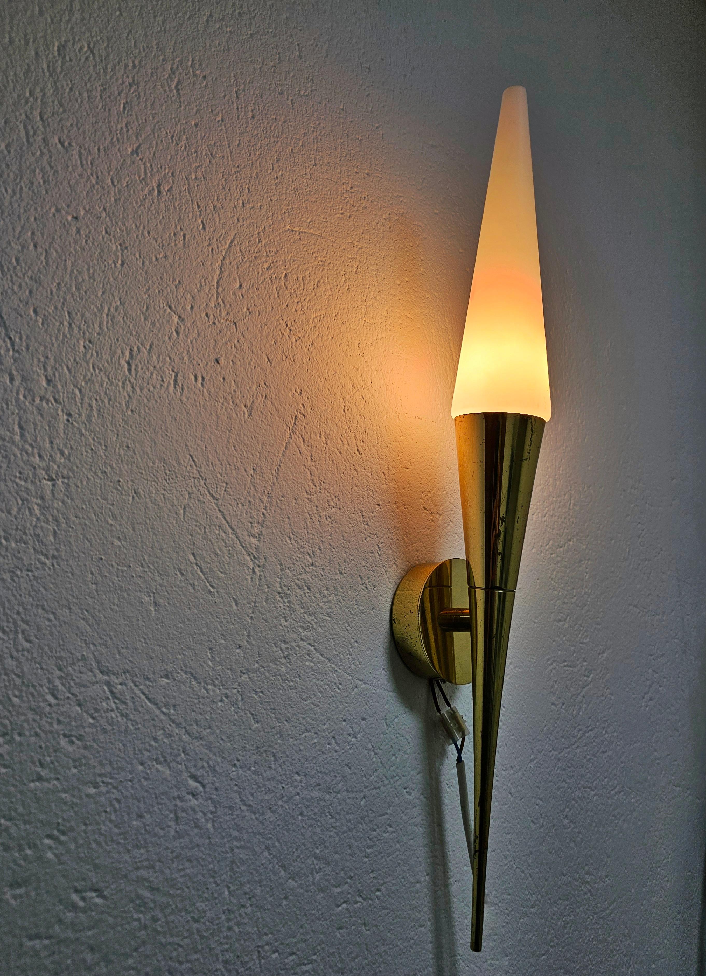 Listed price is per piece.

In this listing you will find gorgeous and very elegant Mid Century Modern sconces done in brass and opaline glass and manufactured by Limburg. Manufacturer's label is still attached.  They feature long, pointy and very