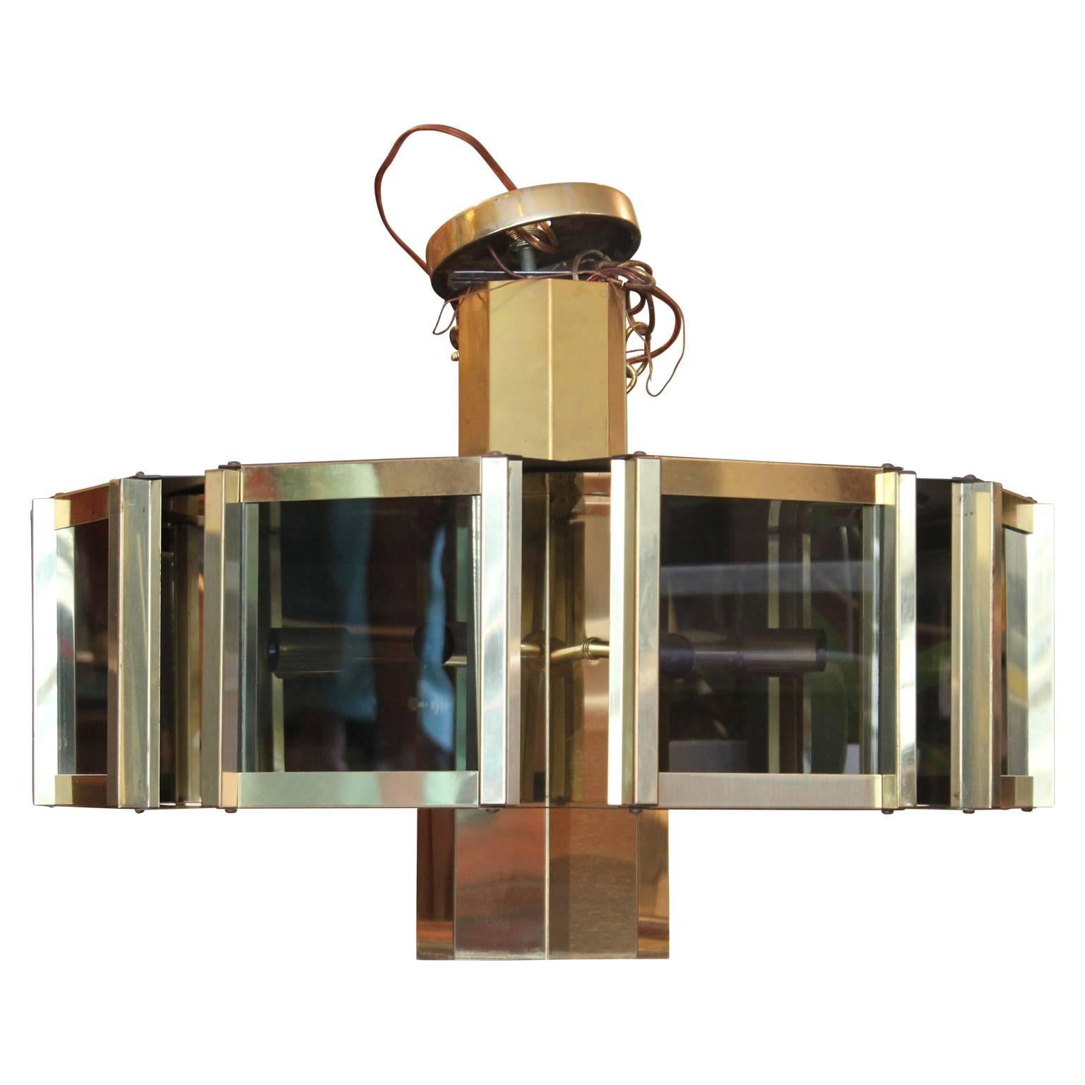 Gorgeous Mid-Century Modern brass and smoked glass pendant chandelier by Ramond Redrick. Features lights in the middle and one light at the very bottom.