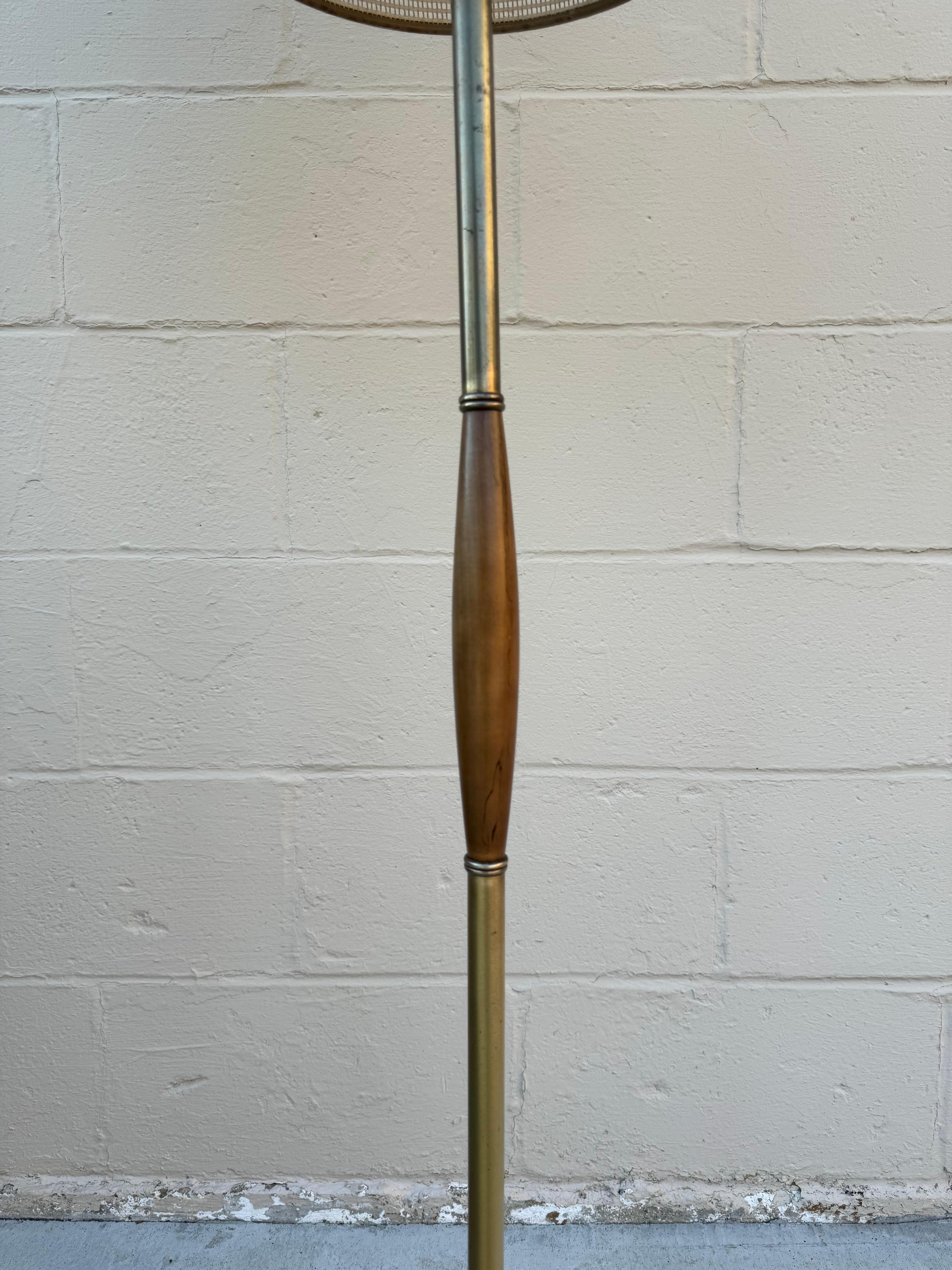 For sale we have a gorgeous mid century modern floor brass floor lamp with wood accent. This floor lamp is finished with a beautiful fiberglass double drum shade.

This mid century modern floor lamp is in excellent working condition and in sound