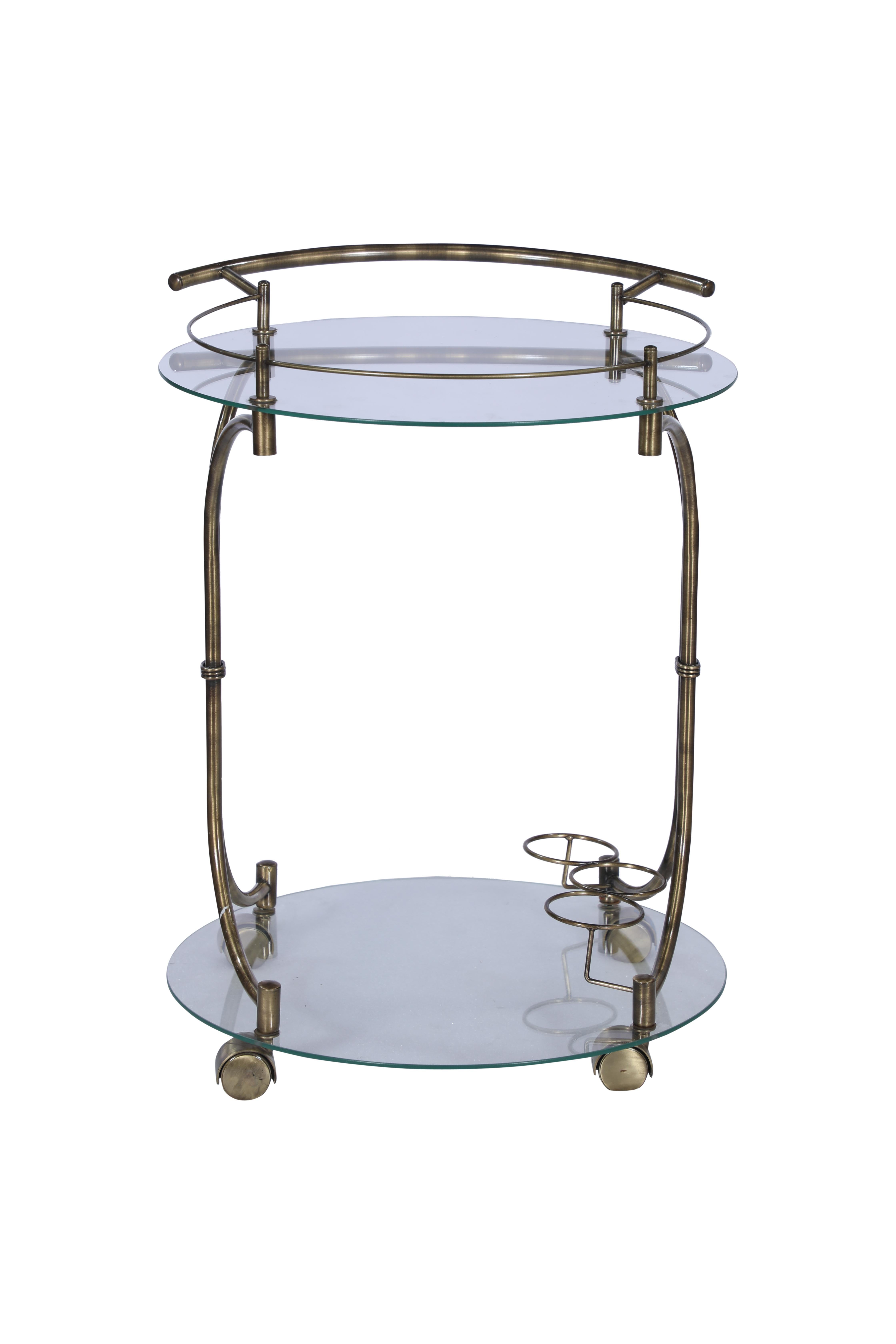 A handsome Mid-Century Modern brass bar cart with glass shelves. Features a handle on one side for moving around, and round swiveling wheels which allows it to do just that. It also has three round bottle holders at the bottom and a rail around the