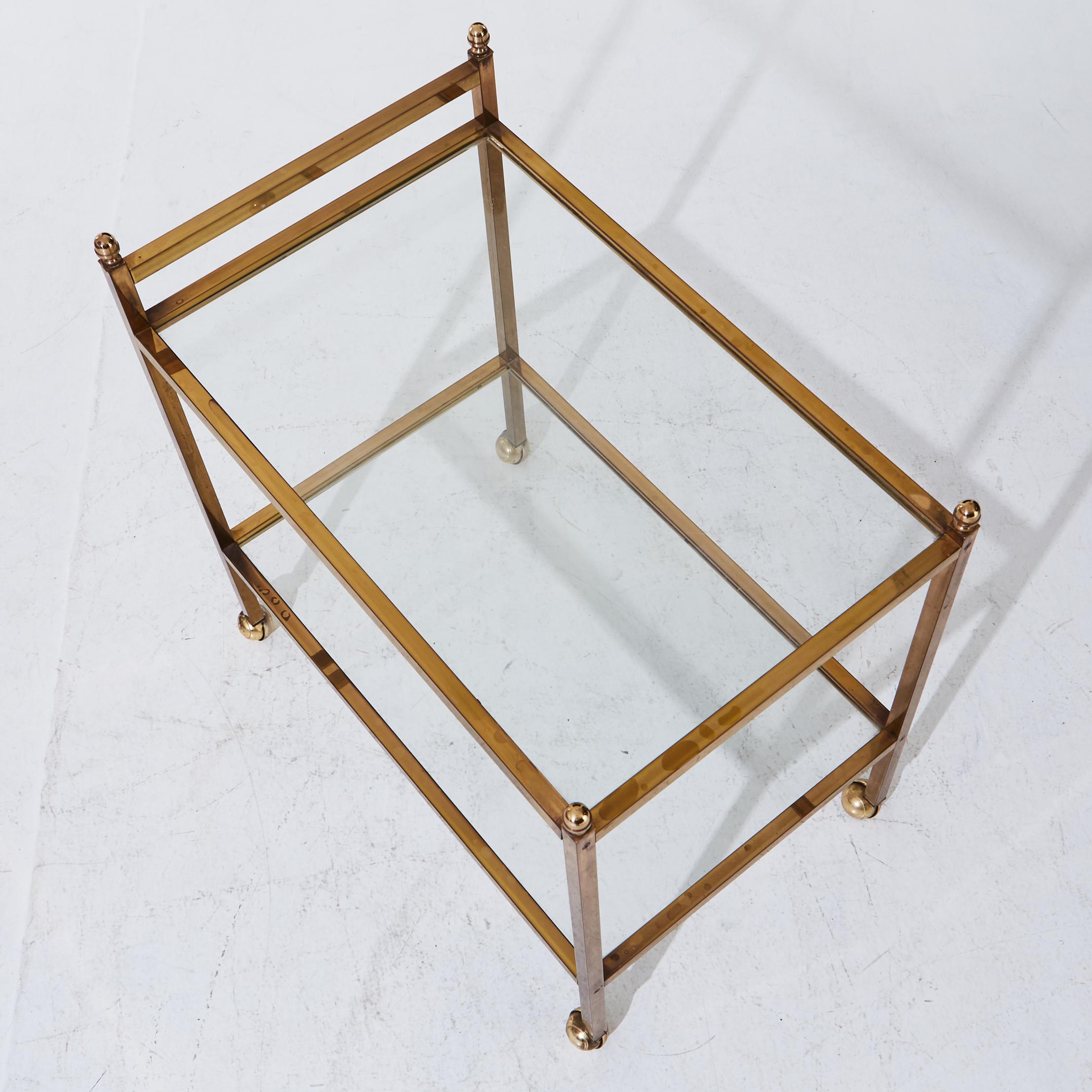 Mid century brass bar cart with two glass shelves 
Height about 26.75 in. 
  