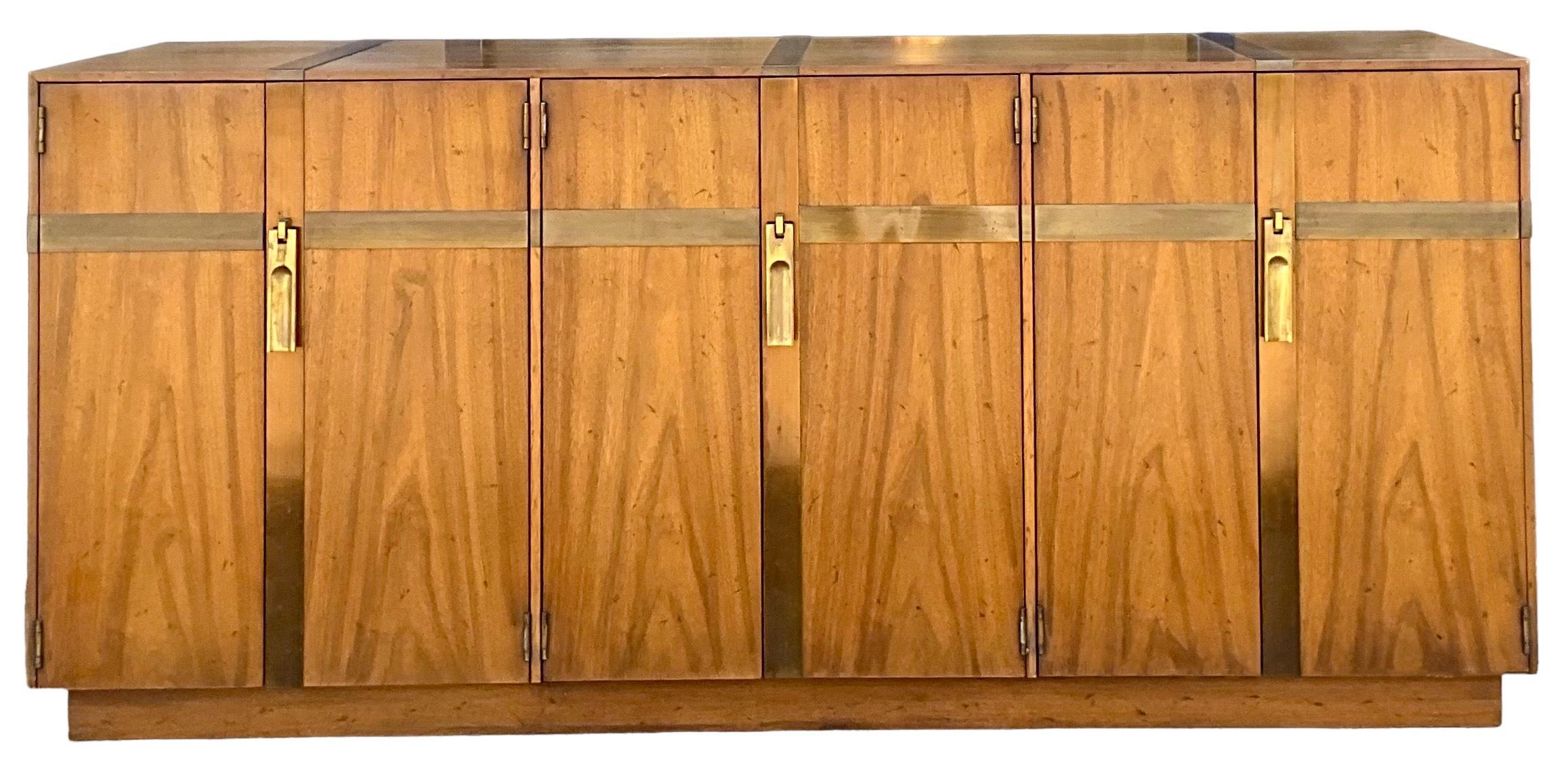 I love this! It is a mid-century modern brass bound walnut credenza by Heritage. It opens to three sections of storage. It is in very good vintage condition.

