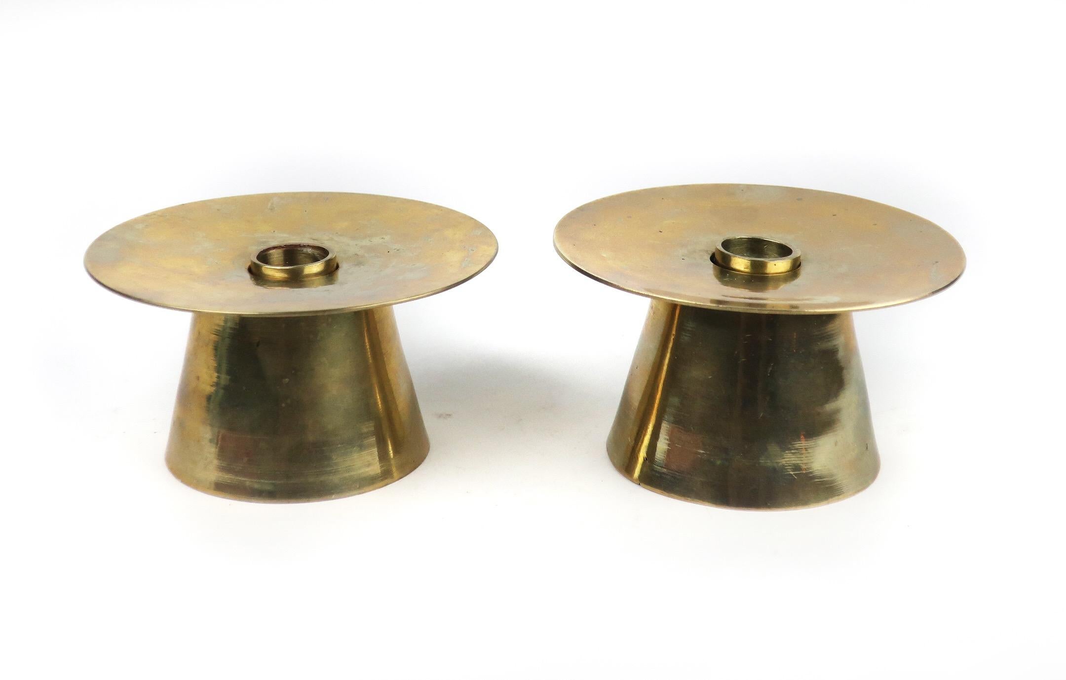 A pair of lovely midcentury or Danish modern brass candleholders with tapered cylindrical bases and wide plate top to catch dripping wax. Each has a removable insert for using with multiple sized candles.

In excellent condition. Designer and