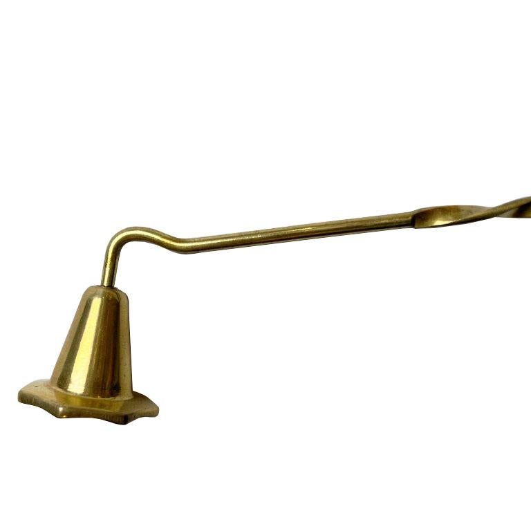 A long brass candle snuffer, made in India. Created from brass, this long candle snuffer will be a beautiful accent on any side table. With a long twisted handle, it will make snuffing candles a breeze. (P.s. Did you know that snuffing candles