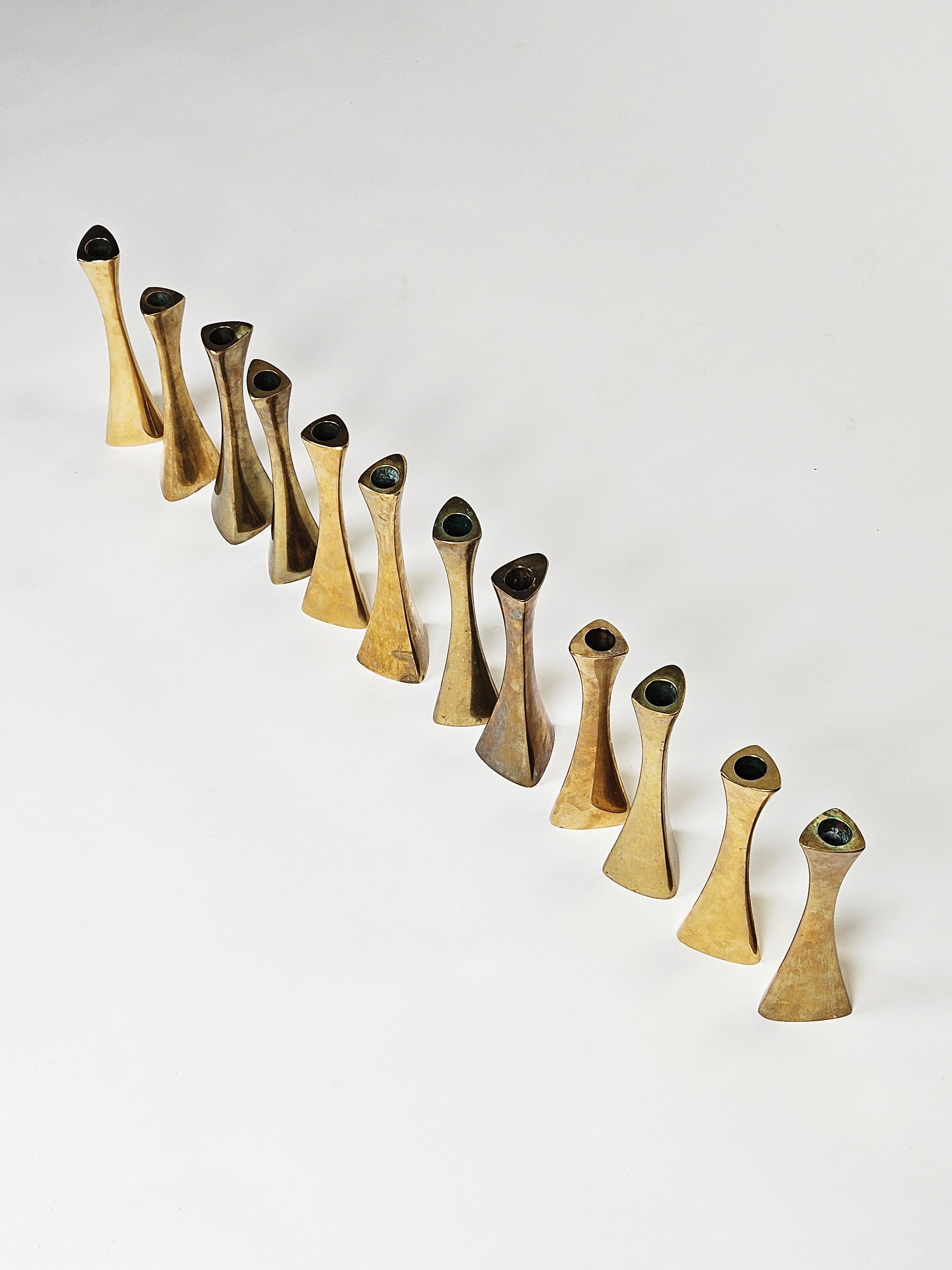 Big set of 12 candleholders model 4973 in solid brass designed by K. E. Ytterberg for BCA Eskilstuna, Sweden, during the 1960s.

Organic shape and made in solid brass. 

Patinated surface. 