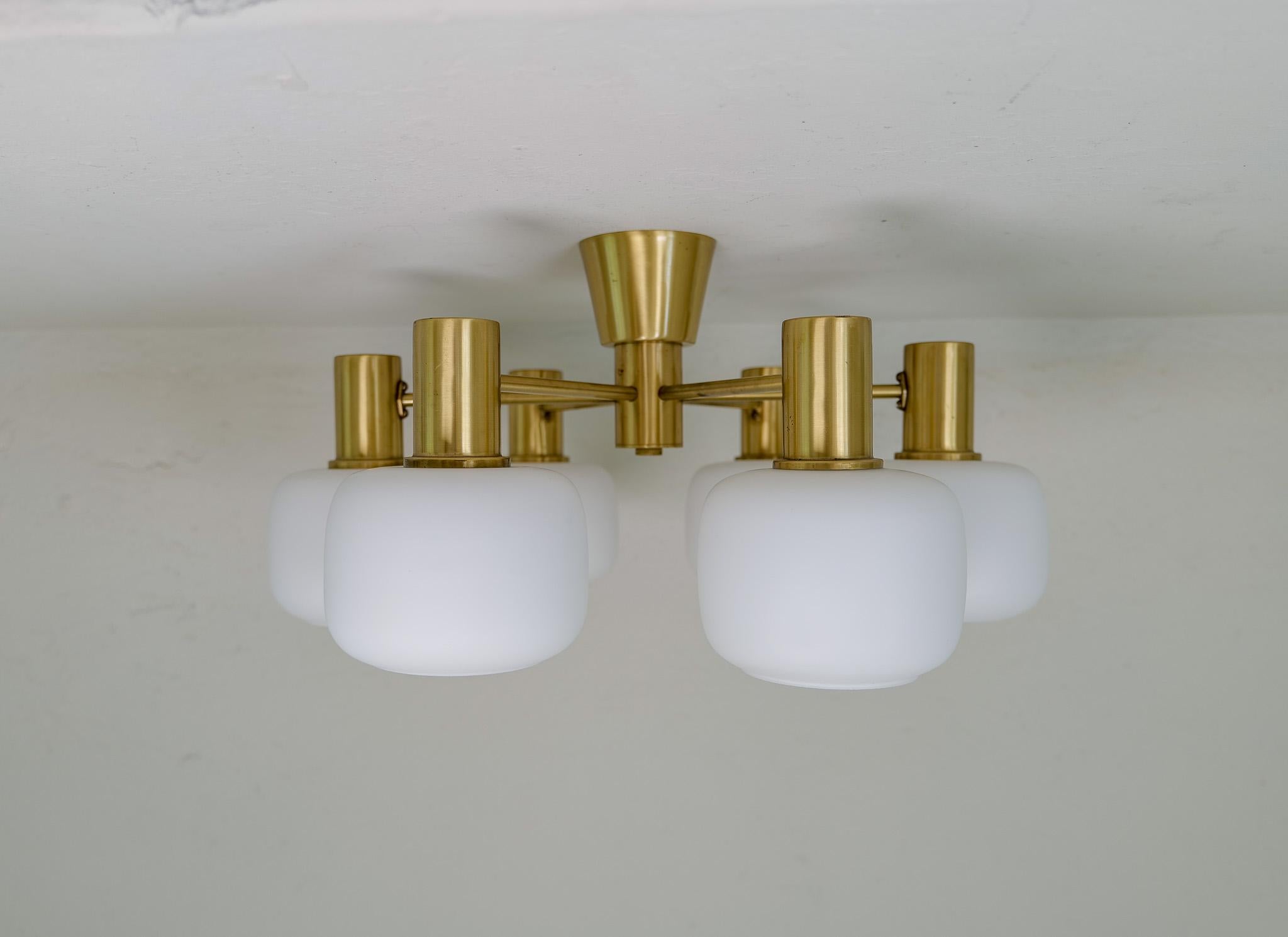 This ceiling fixture was produced by ASEA, Sweden, 1940-1950s. The opaline glass shaped this way gives a great impression and is unusual to find. 

Good vintage condition with marks on the brass and some on the glass. 

Dimension: Height 31 cm