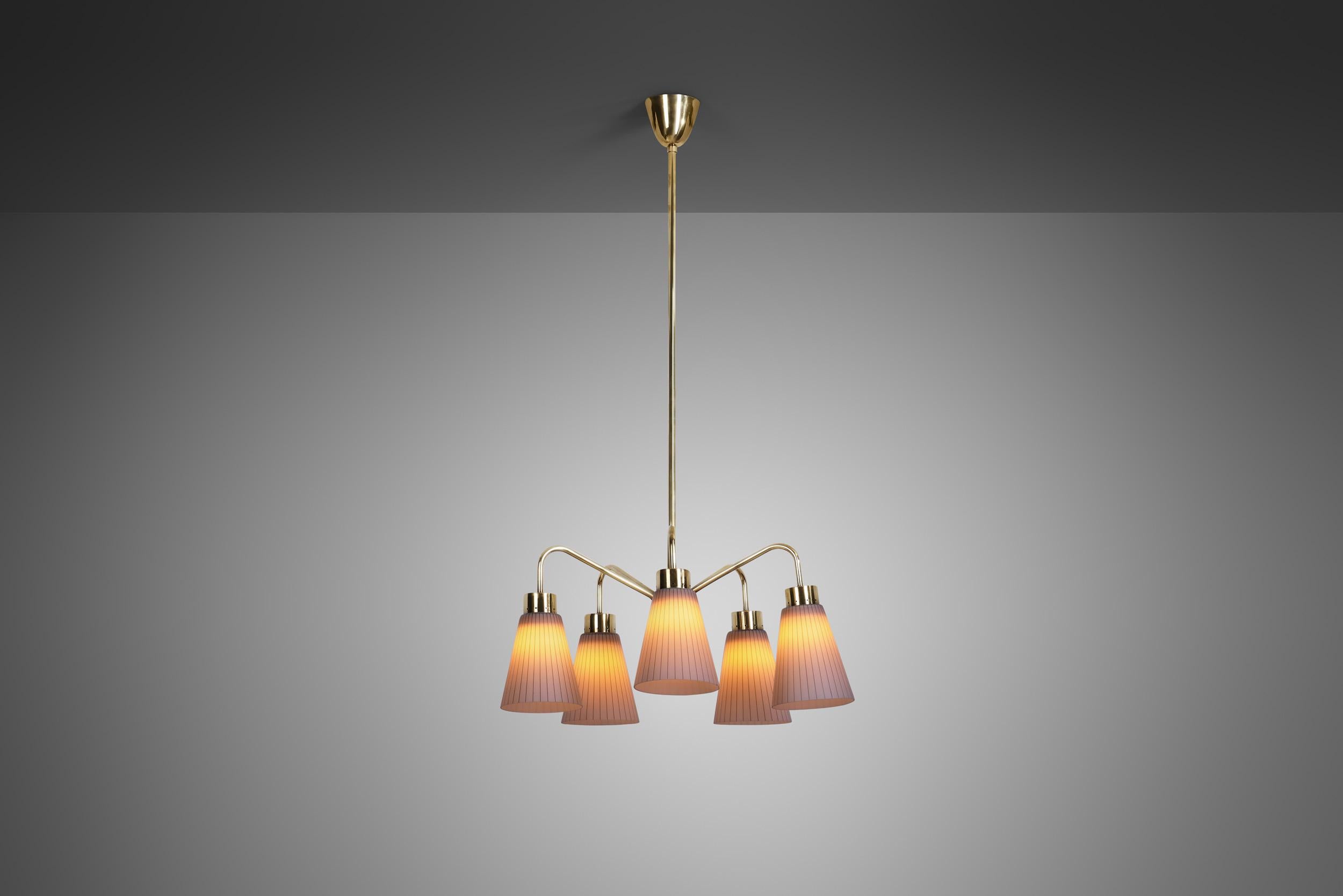 This brass and glass chandelier is full of personality, with unexpected details that make it unique. Most likely a one-off, this model has an essentially mid-century modern look with lovely accents and impeccable craftsmanship.

There are a number