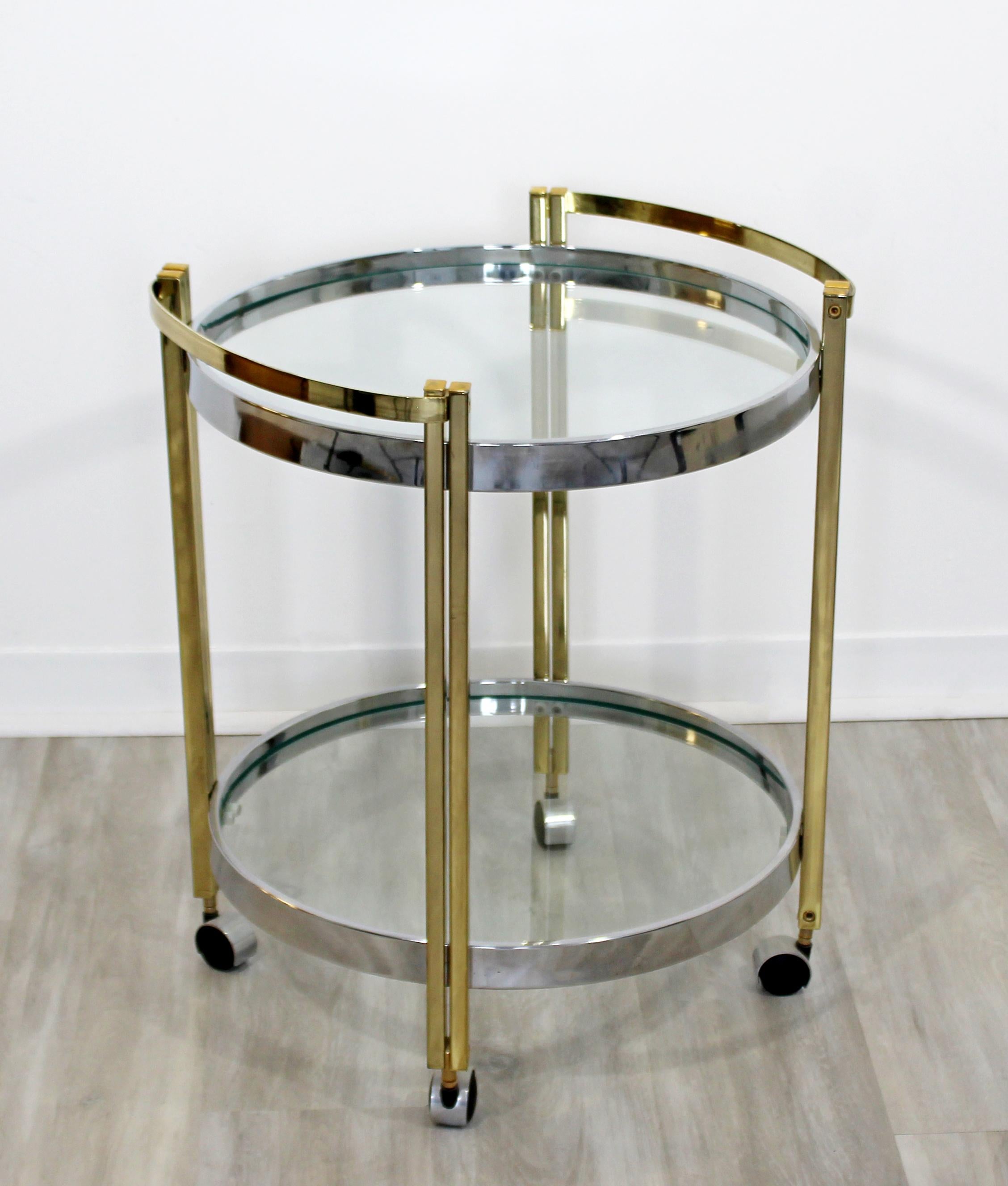 For your consideration is a phenomenal trolley cart, on wheels, made of chrome and brass and with two glass shelves, circa the 1970s. In very good vintage condition. The dimensions are 20.5