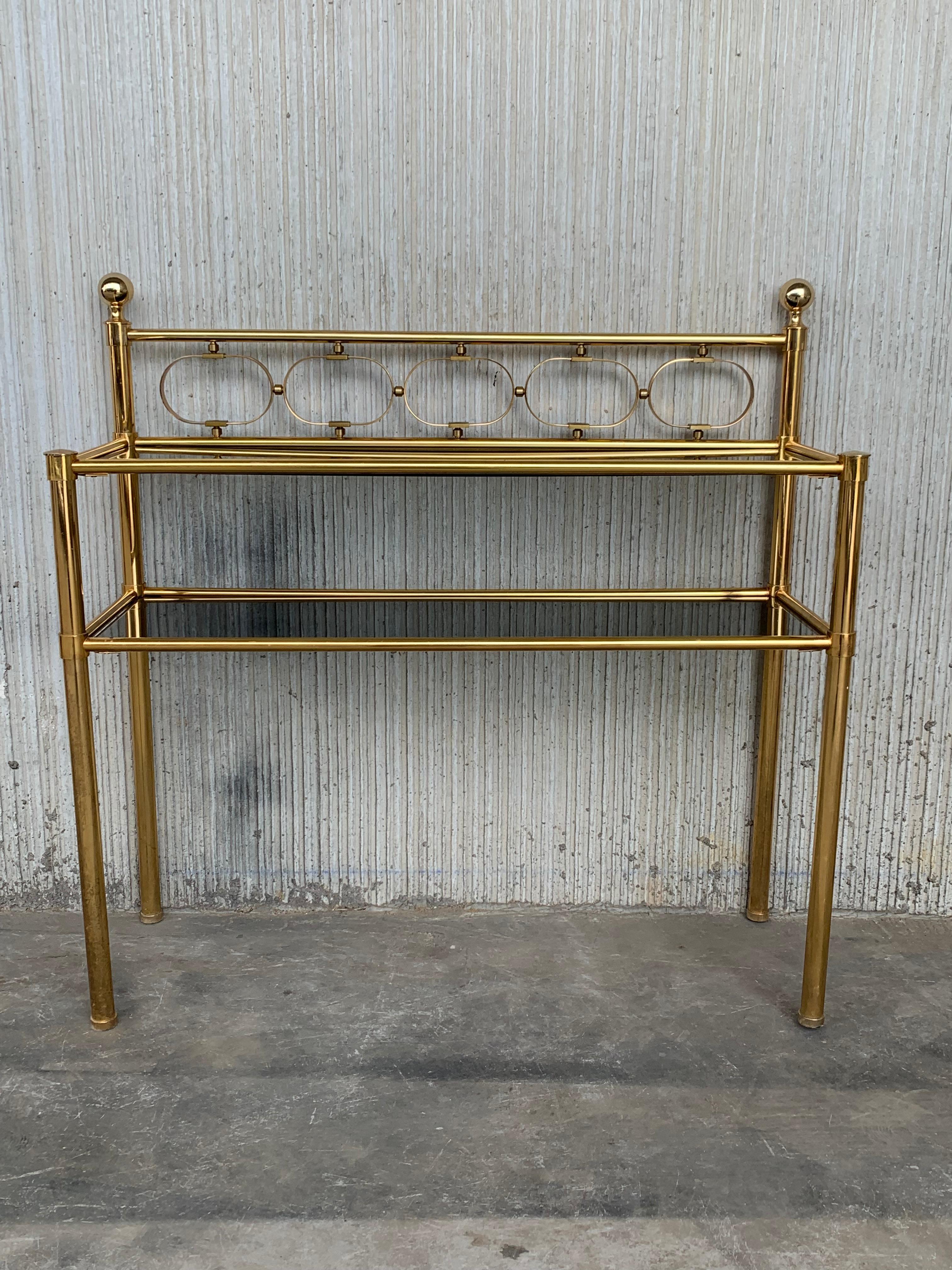 Mid-century modern brass console table with two fumee glass shelves

Height to the low shelve: 20.86in
Height to the hight shelve: 29.52in.
