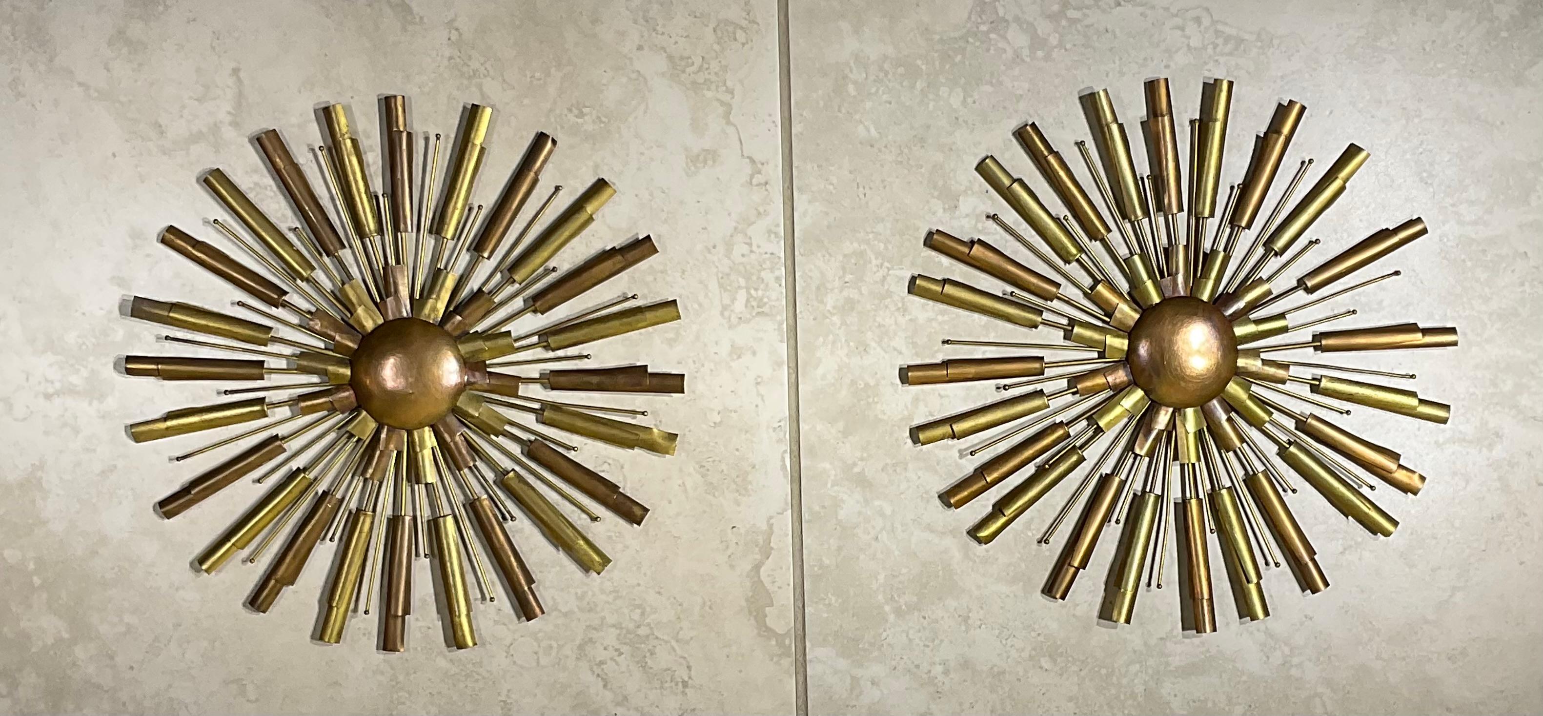 Elegante par de medallones de pared vintage de estilo moderno de mediados de siglo. Estas cautivadoras piezas presentan un dinámico diseño inspirado en el Sputnik, que irradia calidez y sofisticación. Elaborados con una hermosa combinación de latón