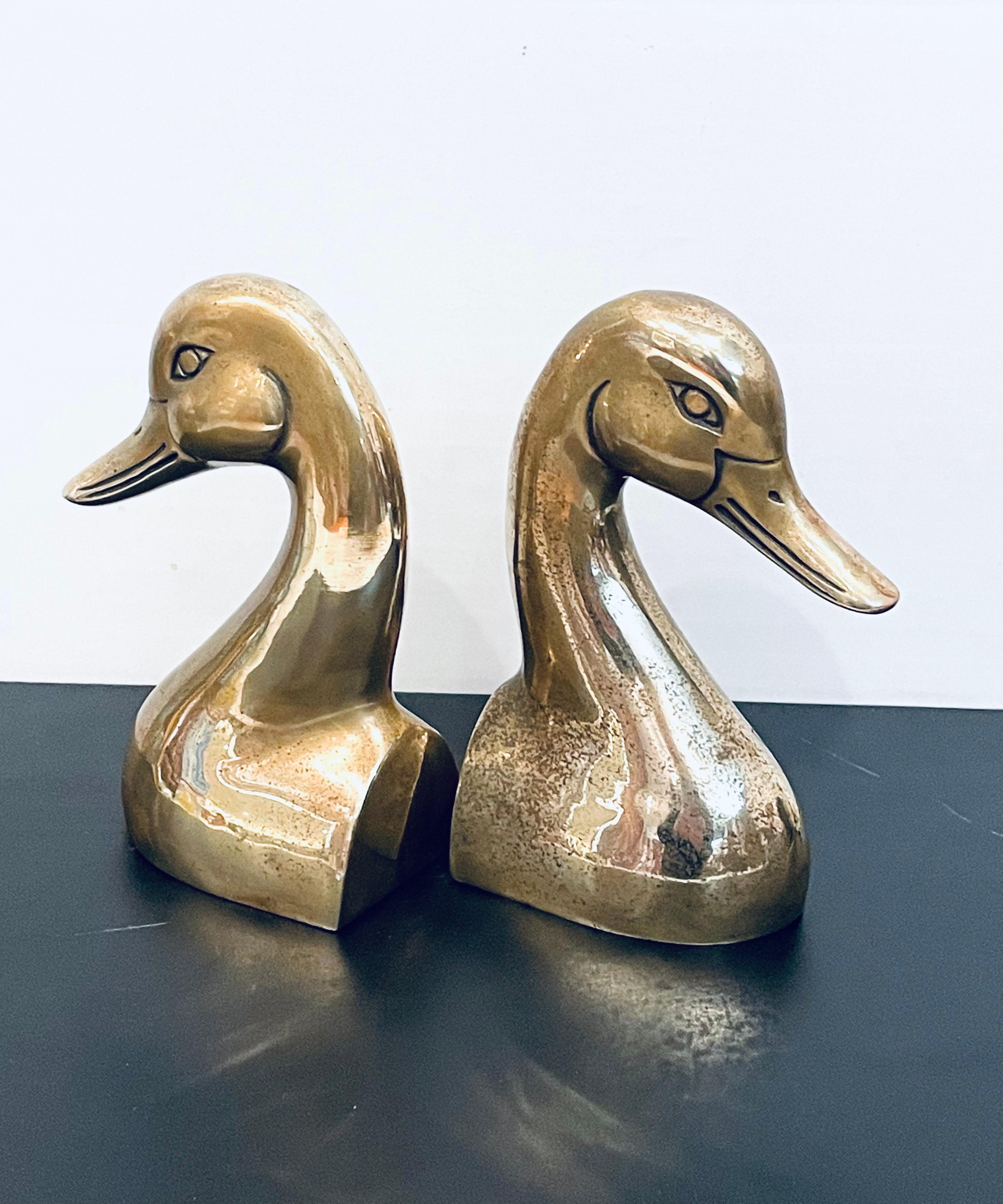 Nicely light polished brass bookends, duck heads, circa 1970s.