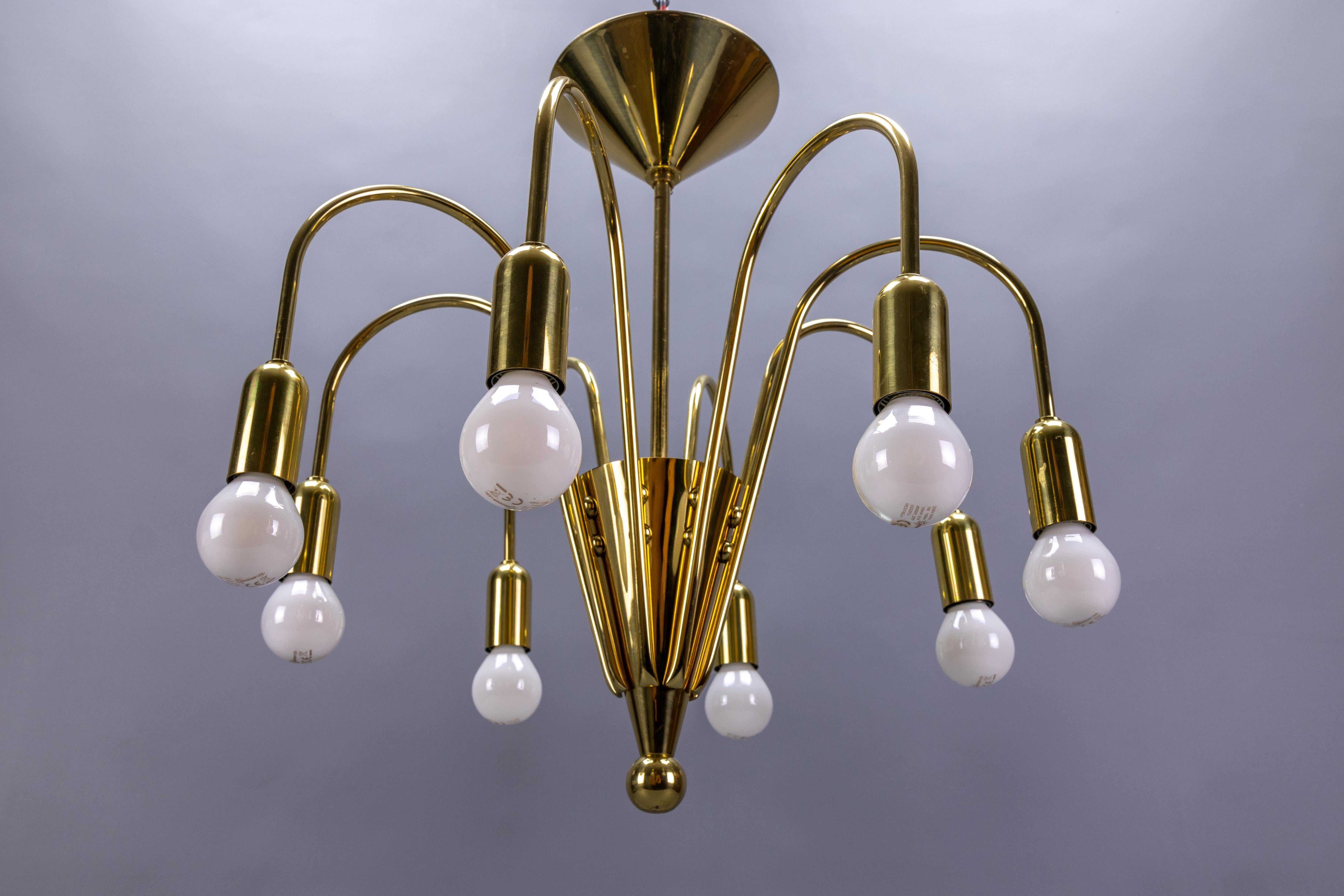 Mid-Century Modern brass eight-light Sputnik chandelier by TZ Leuchten, Germany, circa the 1970s.
An elegant sputnik-shaped eight-light pendant chandelier with eight sockets for E14-size light bulbs.
Dimensions: height: 40 cm / 15.74 in; diameter: 