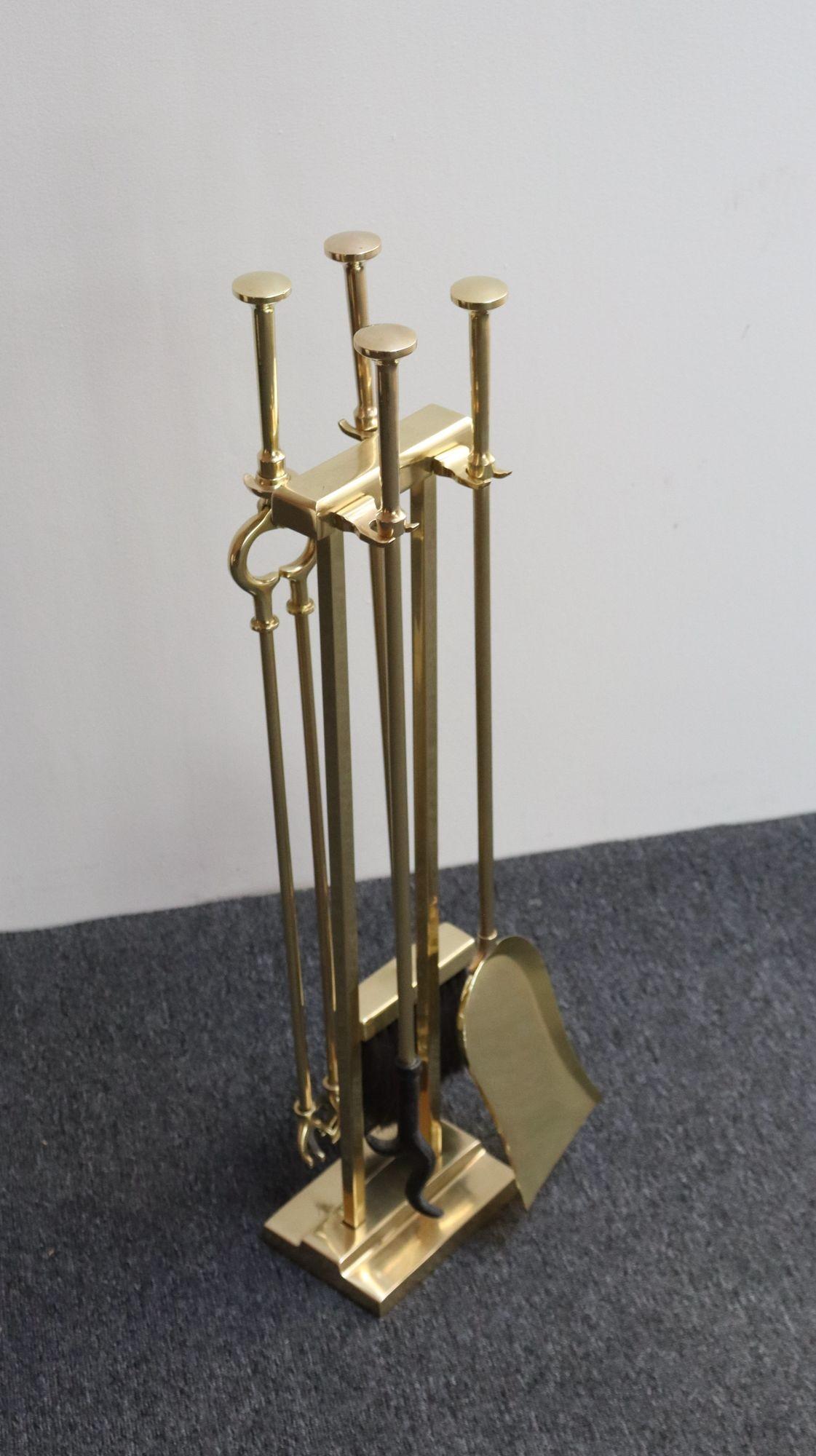 Vintage fireplace tool set including the stand, shovel, broom, poker, and tongs (ca. 1950s, USA).
Tongs feature 'hand' grabbers reminiscent of a design by Carl Auböck, though maker is unknown.
Luxurious set in newly polished condition with only a