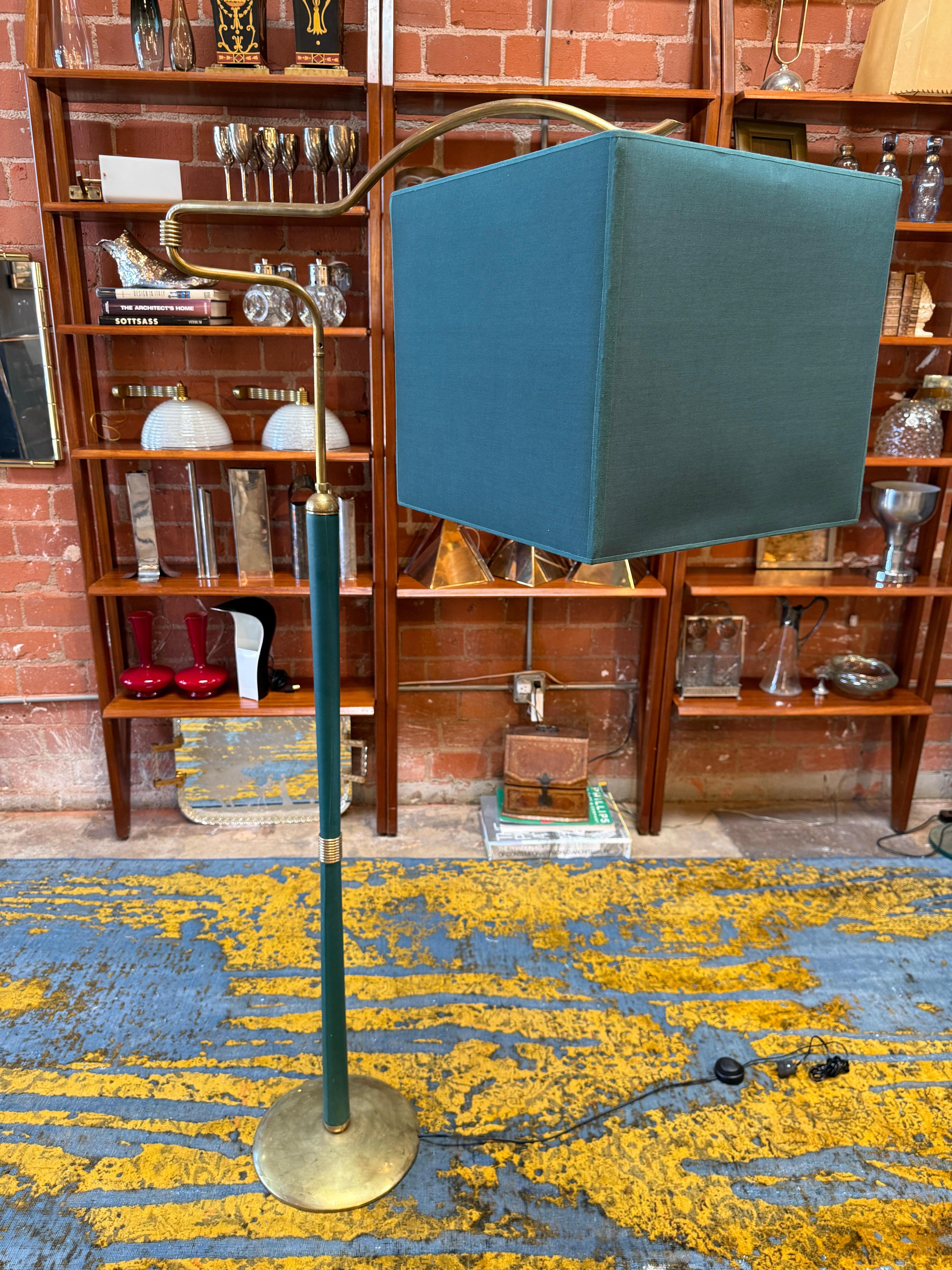 This striking mid-century modern floor lamp combines sculptural design with functional elegance. Featuring a gracefully curved brass arm and a bold teal square fabric shade, the lamp adds a sophisticated pop of color to any interior. The slender