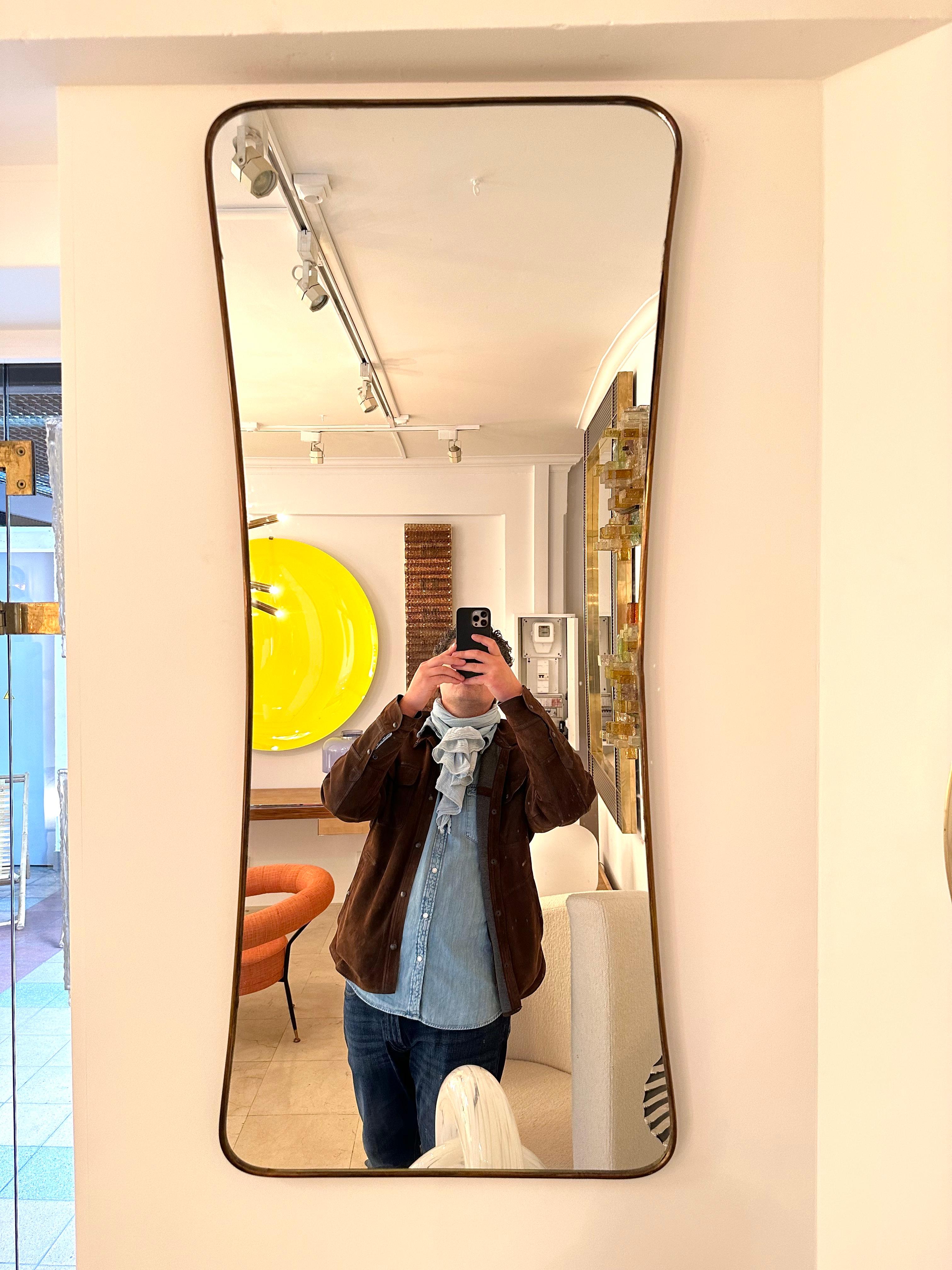 Mid-Century Modern rectangle freeform brass frame mirror. Nice patina. Gio Ponti placed this style of mirror in his interiors during the 1950s and 1960s.

Price listed by mirror. In sale separately.
For the pair please indicate quantity X2 at