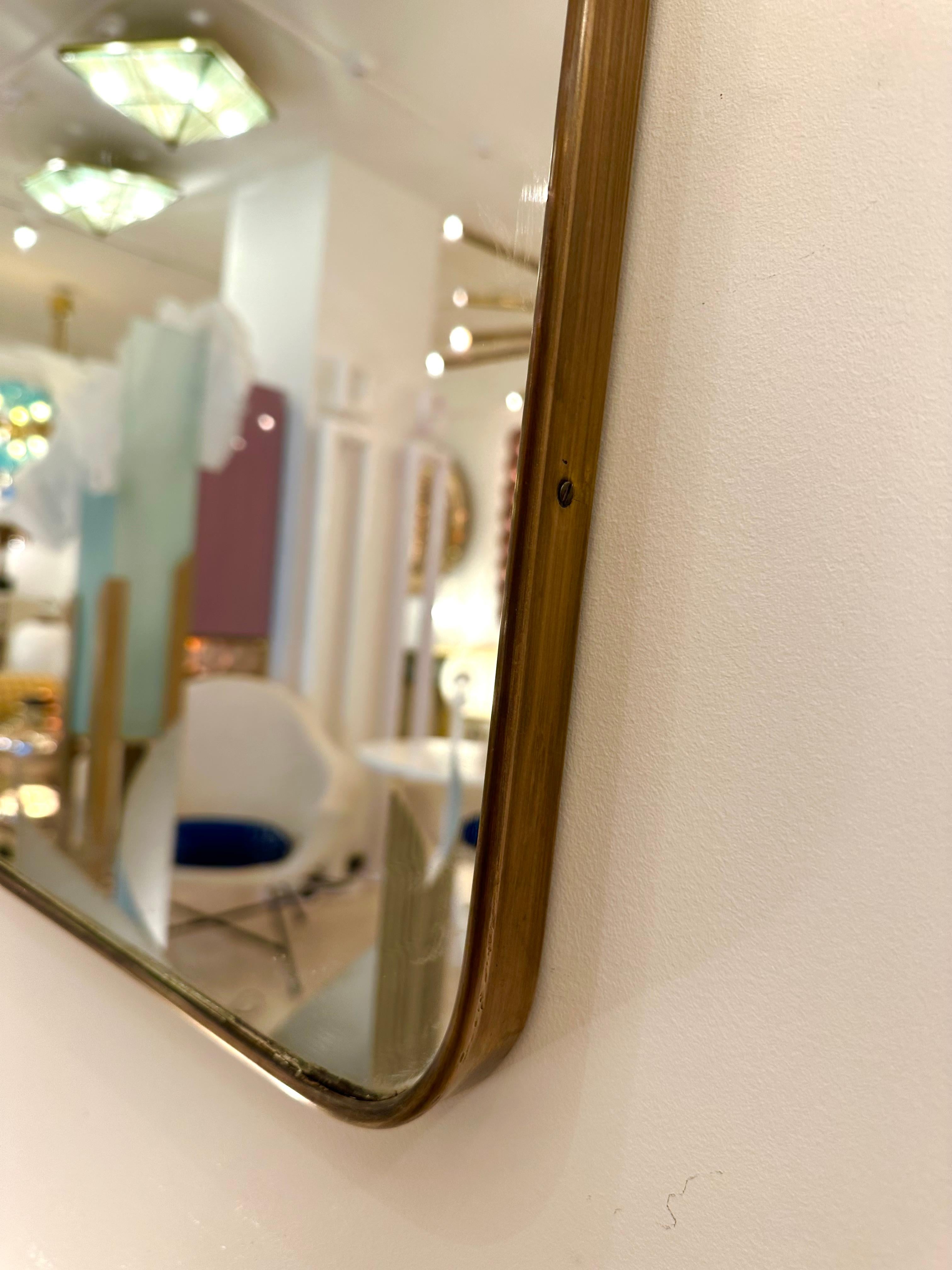 Mid-Century modern rectangle brass frame mirror. Nice patina. Gio Ponti placed this style of mirror in his interiors during the 1950s and 1960s.

Price listed by mirror. In sale separately.
For the pair set or 2 please indicate quantity X2 at