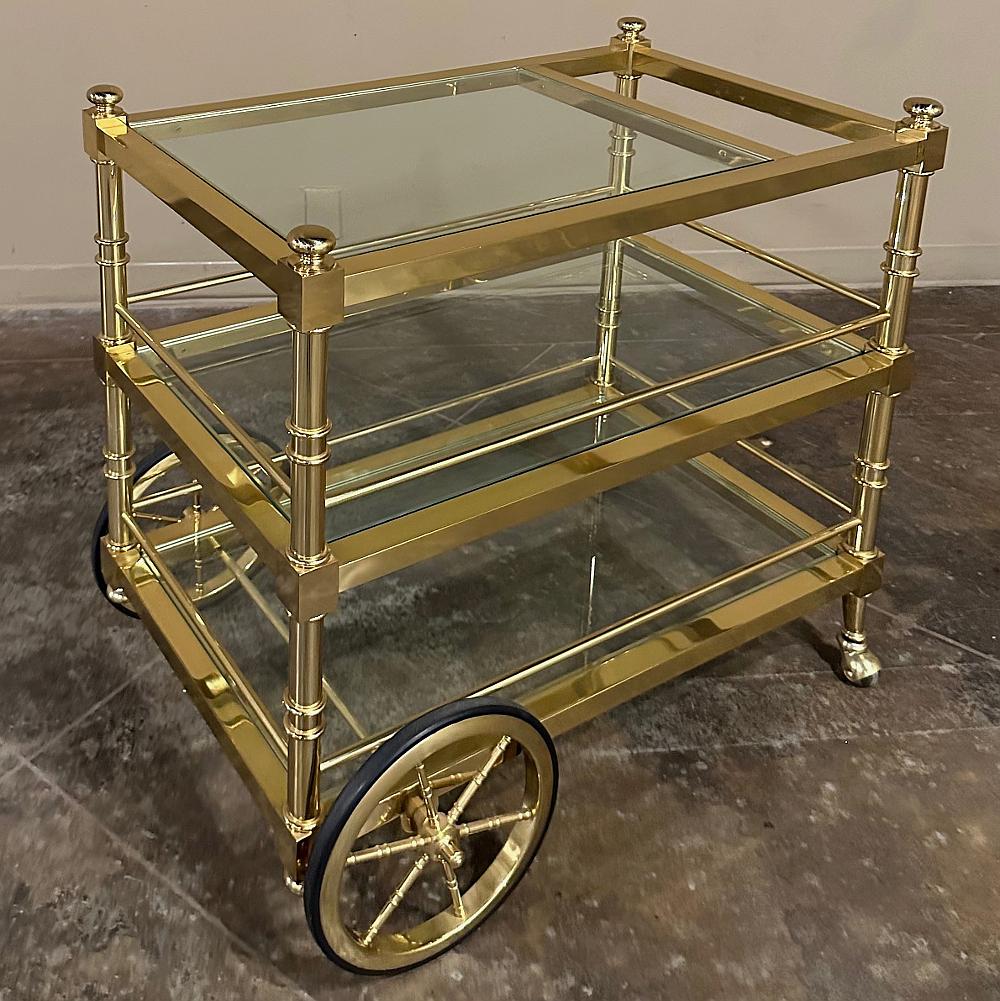 Mid-Century Modern Brass & Glass Bar Cart makes the perfect addition to your entertaining room! Set on spoked wheels on one end and roller wheels on the other, it is easily moved to any part of the room for ease in serving. Perfect for desserts,