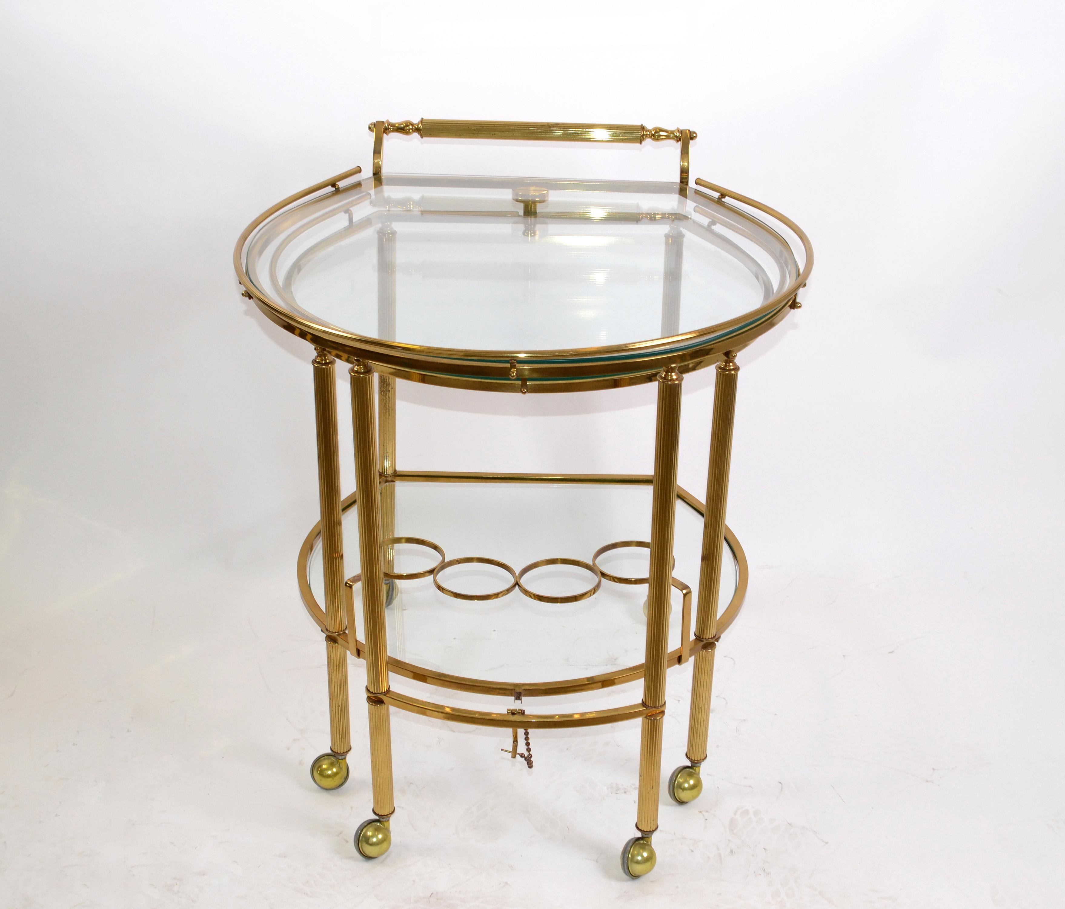 Mid-Century Modern brass and glass extendable two table bar cart, trolley on casters made in Italy, 1960.
Can be arranged in different angles around a sofa, table or dry bar.
Listed with the dimensions extended.
Measurements:
Big table: Length