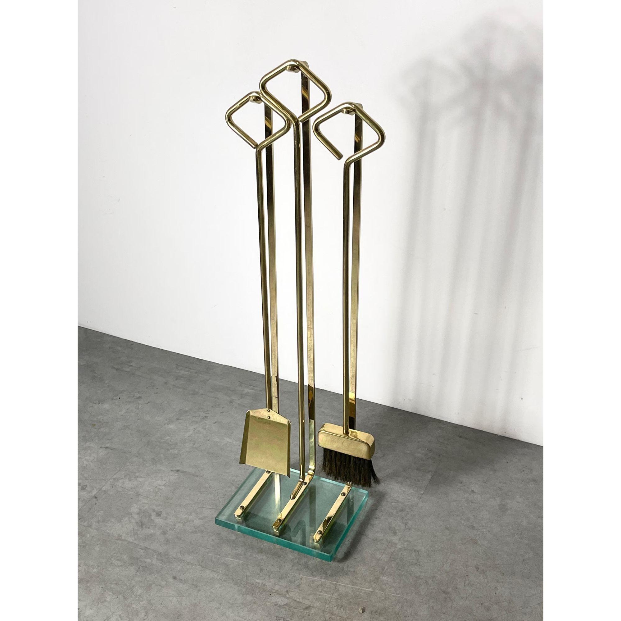 Vintage Italian Modern Brass Glass Fireplace Tools 

Impressive modern fireplace tool set attributed to Fontana Arte circa 1970s
Solid polished brass tools and stand with heavy glass base
Includes shovel poker and brush

Additional