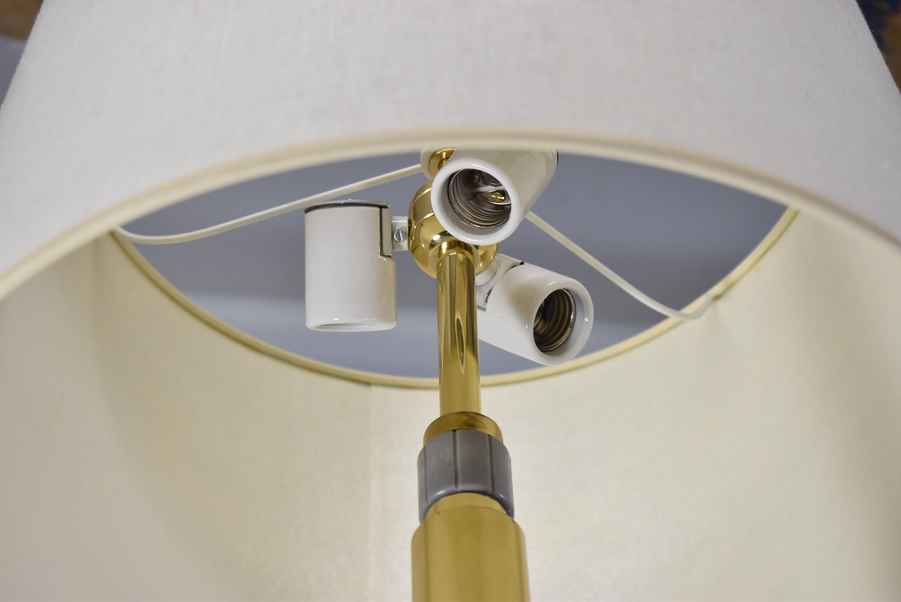 Mid-Century Modern brass and glass floor lamp. Made in the USA by Hansens of New York circa 1970. Three porcelain sockets. Twist turn off on switch. Dimensions: 57