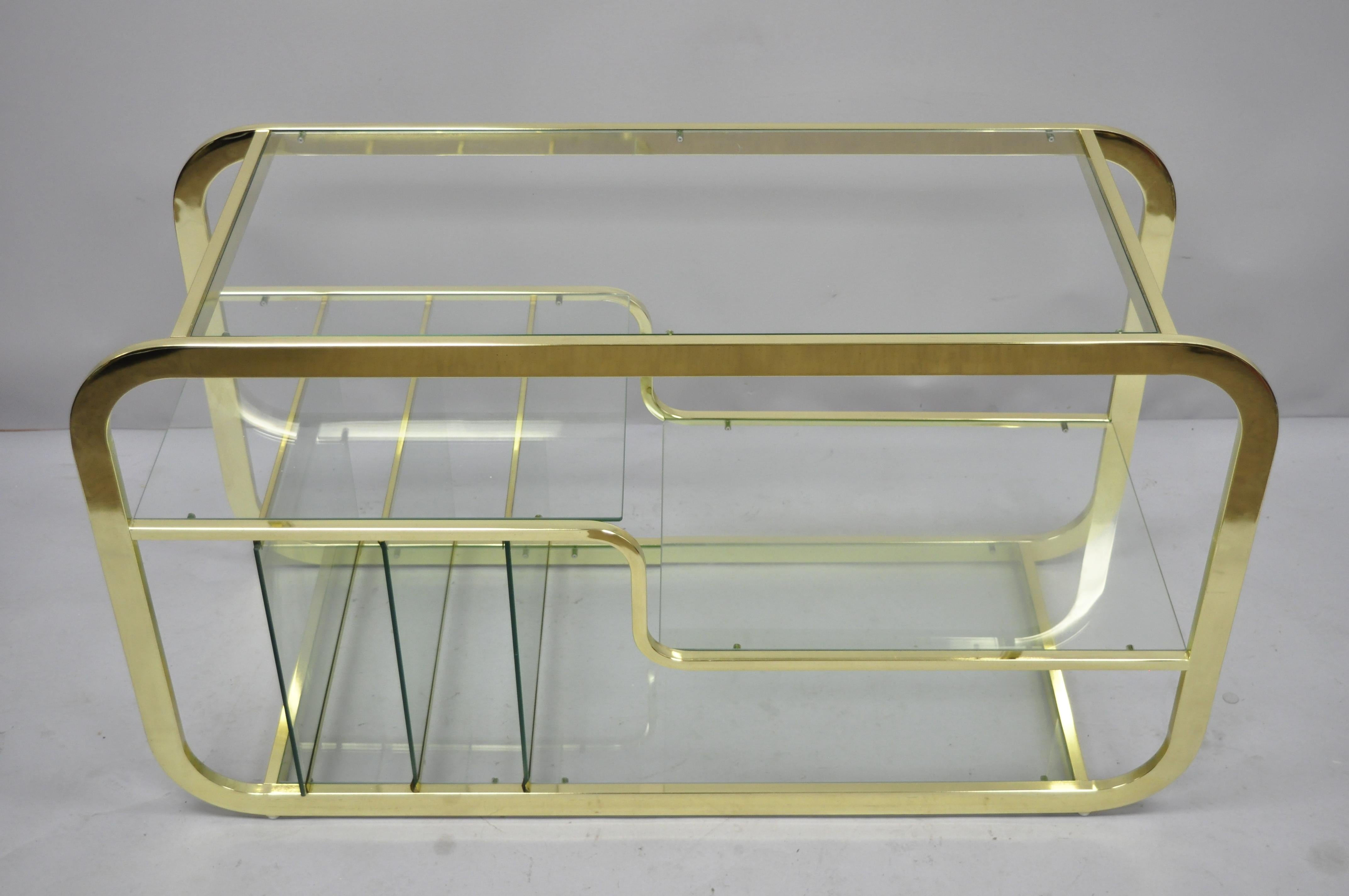 Mid-Century Modern brass and glass server bar after Milo Baughman. Item features 4 glass shelves, 3 glass dividers, brass plated metal frame, clean modernist lines, sleek sculptural form, circa 1970. Measurements: 26