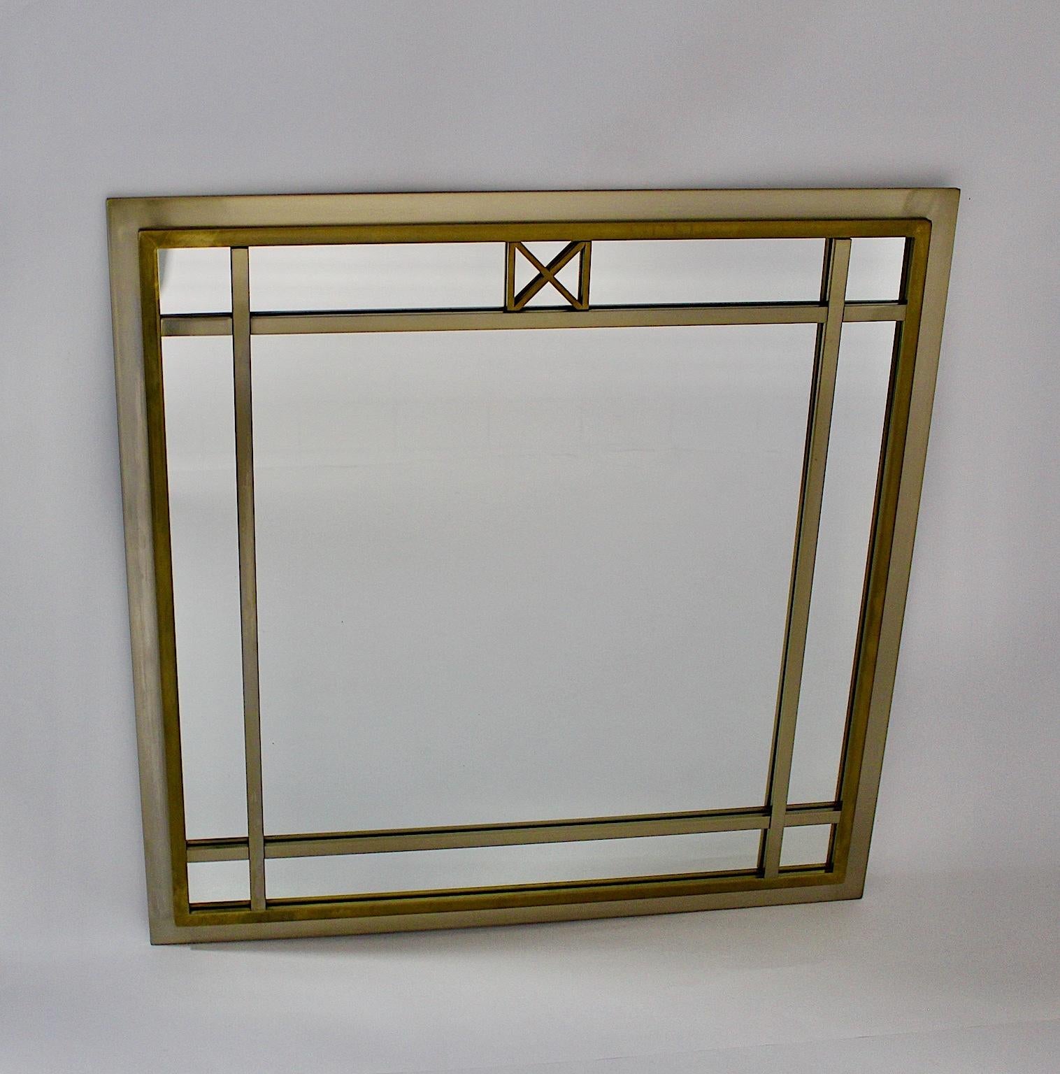 A high, quality Mid-Century Modern vintage wall mirror, which was designed by Romeo Rega attributed, Italy, 1970s.

The rare metal and glass wall mirror was made out of brass, the outer edge of brushed metal and glass mirror.
Romeo Rega was born