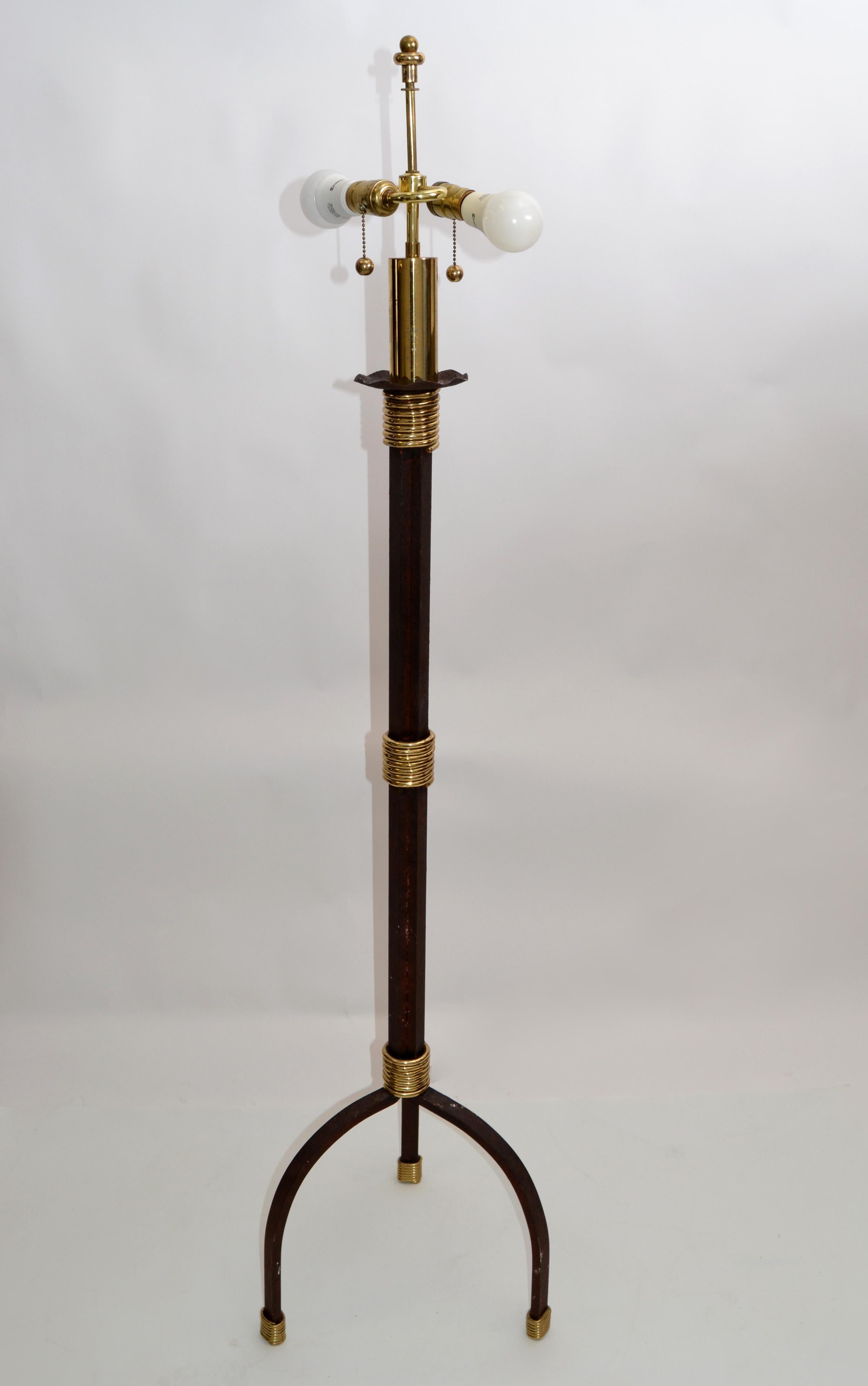 Tall Mid-Century Modern handcrafted floor lamp in burgundy brown iron and brass detail on a tripod base from the 1970s.
Has a 2 socket light with pull strings. 
Takes two regular or LED light bulbs with max. 75 watts.
Shade not included.
 