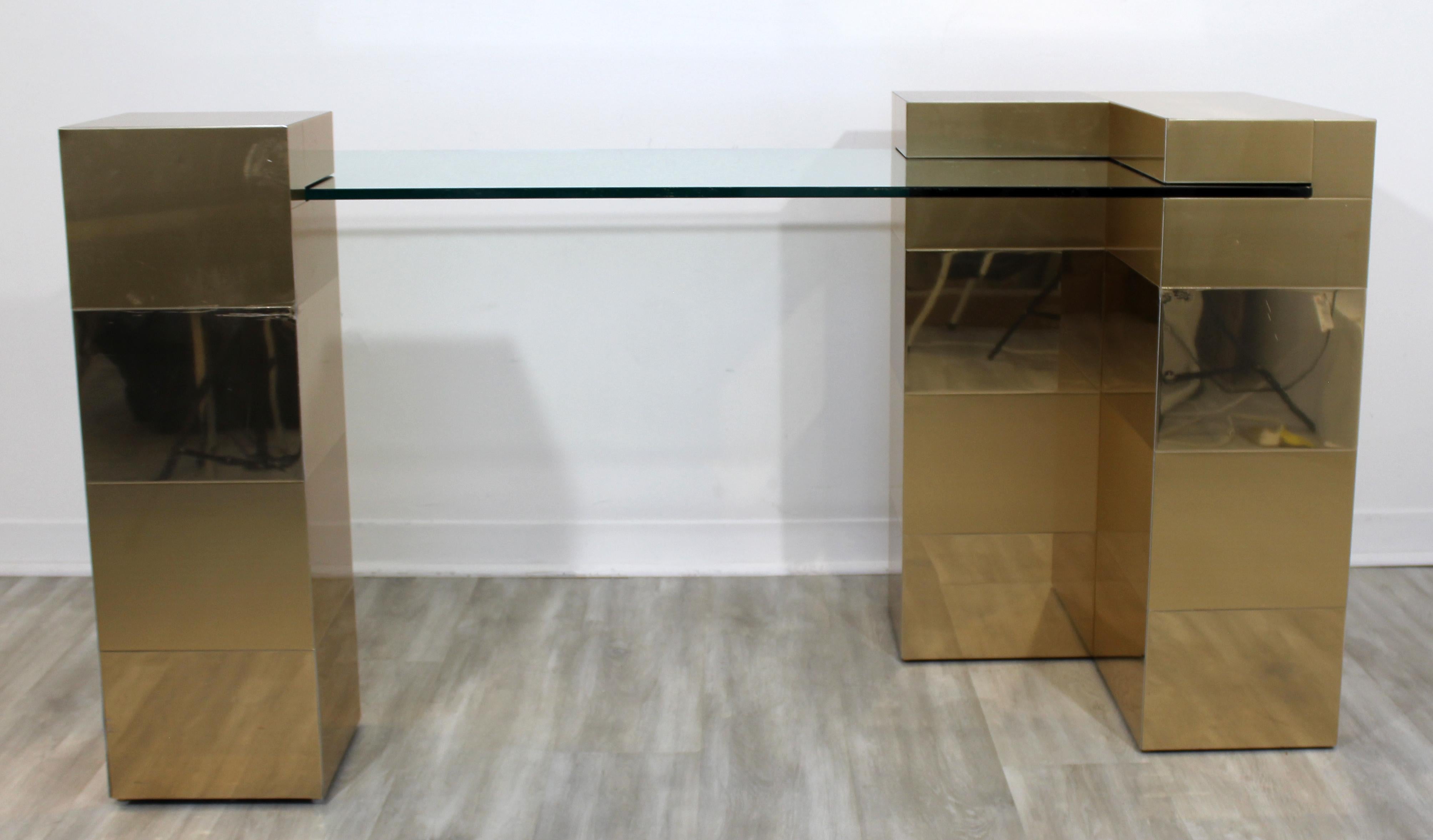 For your consideration is an incredible, brass desk, with interlocking glass top, in the style of Paul Evans' cityscape, circa 1970s. In very good vintage condition. The dimensions are 60