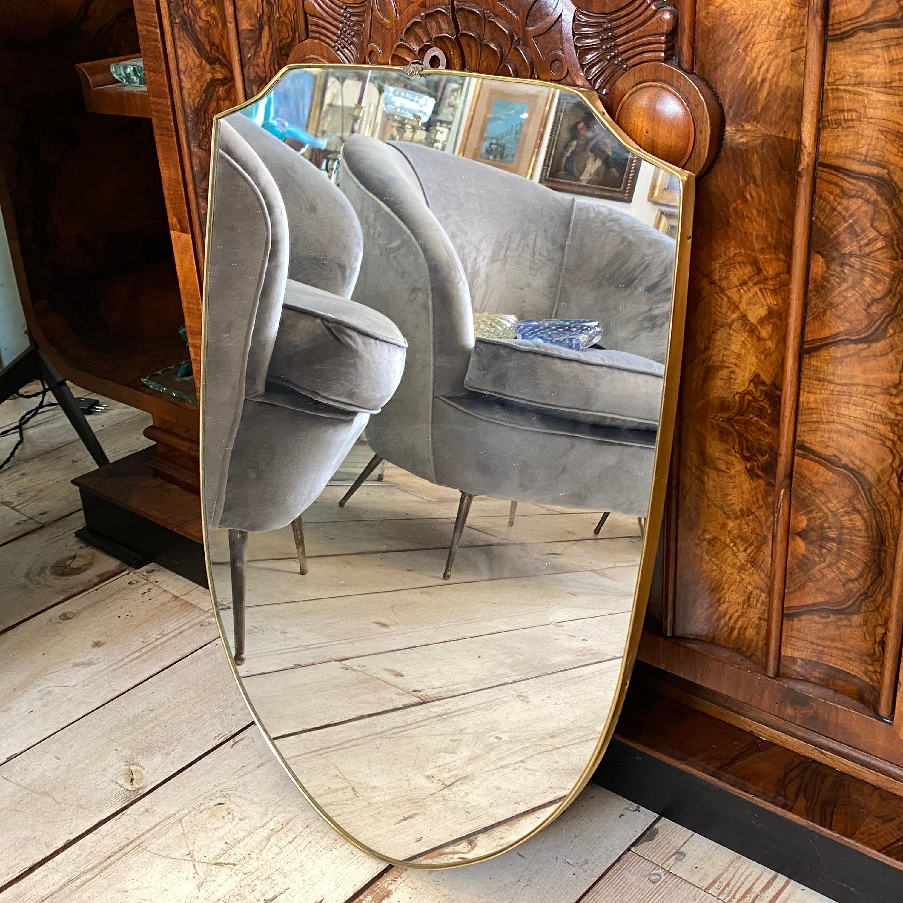 A Brass italian wall mirror made in Italy in the Fifties in the manner of Giò Ponti, good conditions overall.
