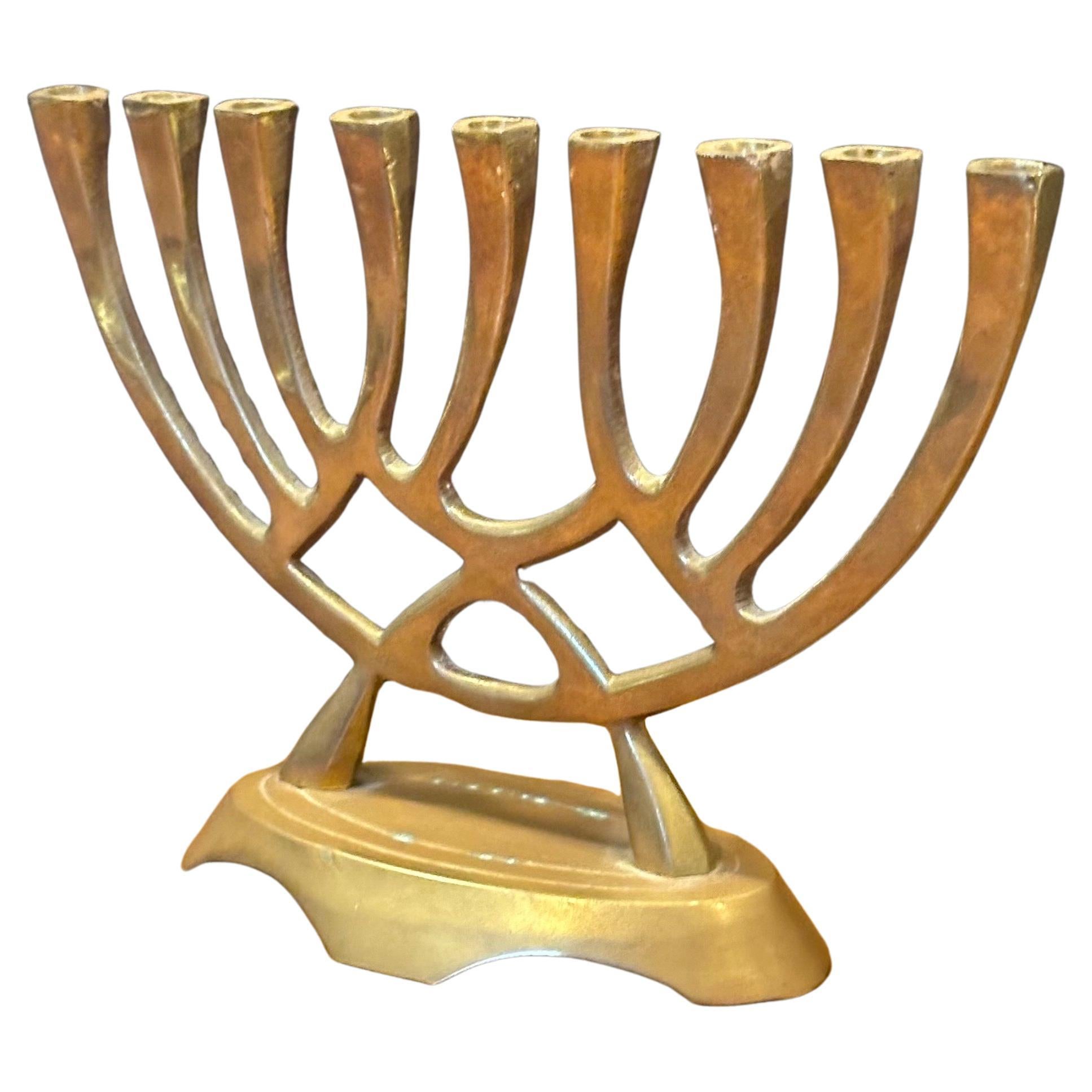 Mid-century modern brass menorah, circa 1970s. The piece is in very good vintage condition and measures 6.5