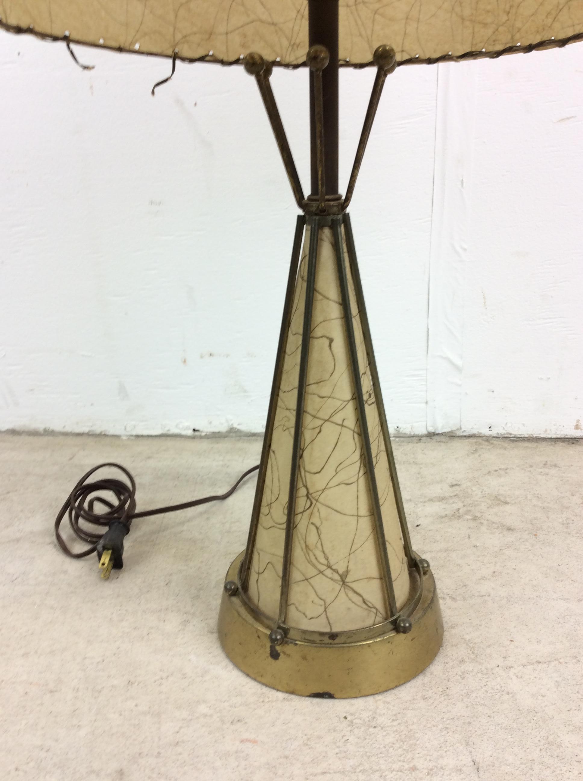 This mid century modern table lamp features brass body with naugahyde interior and a uniquely MCM naugahyde barrel shade.  Matching red table lamp available separately.

Dimensions: 16w 16d 24h

Condition: The vintage brass body of this lamp is