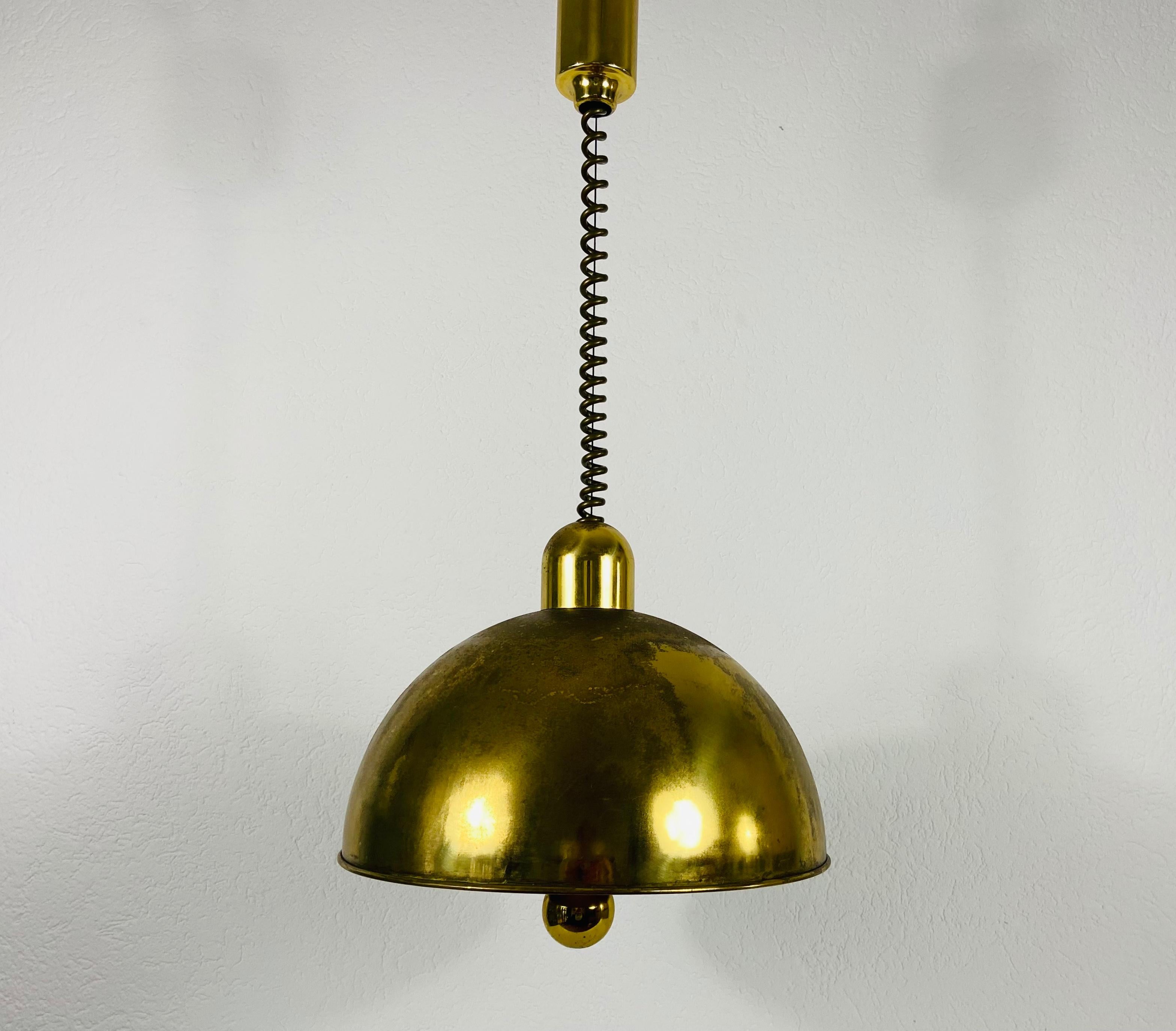 Brass pendant lamp by WKR made in Germany in the 1970s. It is fascinating with its exclusive design. The height of the lighting is adjustable.

Max height: 61 cm
Measurements of shade:
Height 36 cm
Diameter 42 m

The light requires three