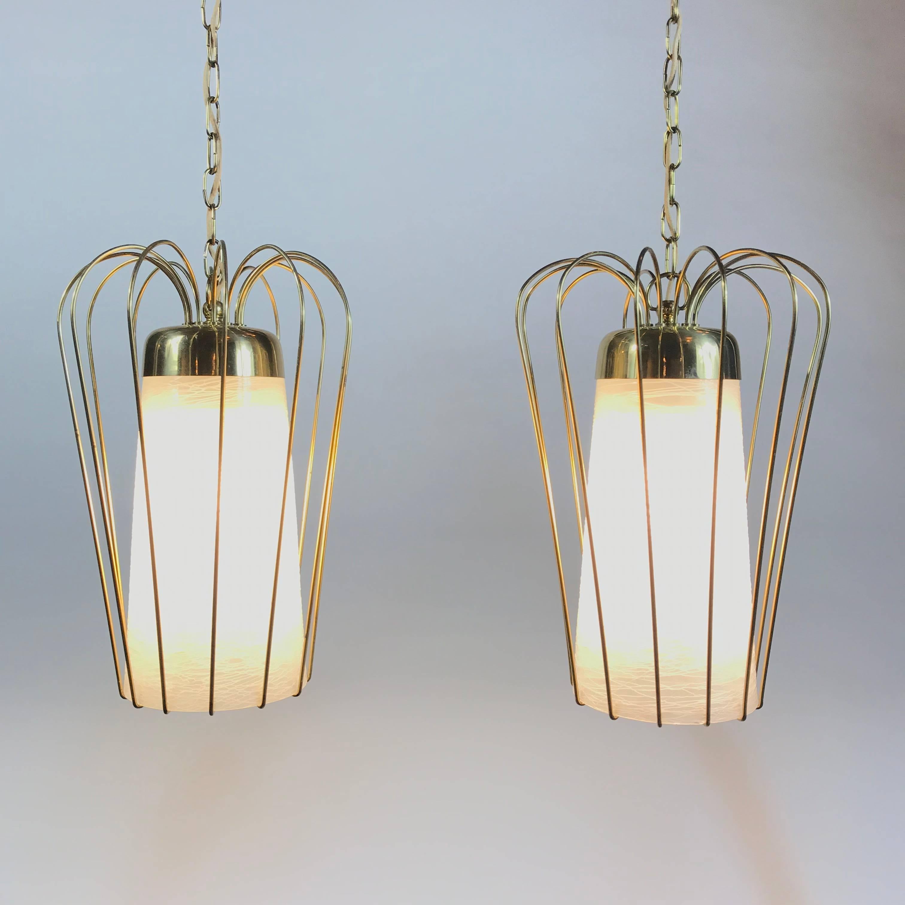 Modernist pendant lamp made by Kalmar in the 1950s. The lamp is made of gilded brass and the lampshade is made of satinated, melted white glass. The lampshade provides a smooth large-area light. 
Fully working and tested condition - E27 socket. Very