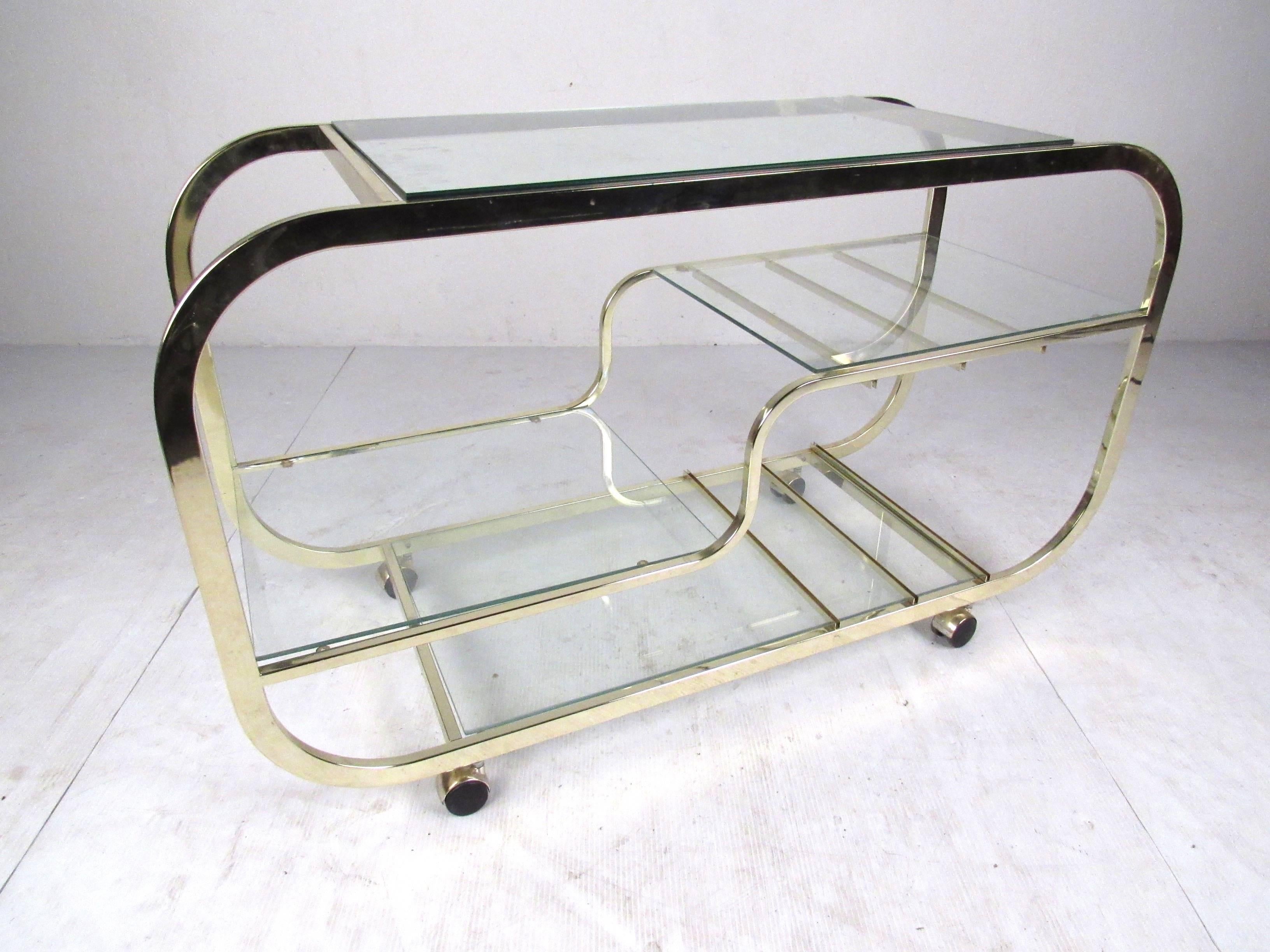 Four-tier waterfall design brass serving/bar cart in the style of Milo Baughman. Please confirm item location (NY or NJ) with dealer.