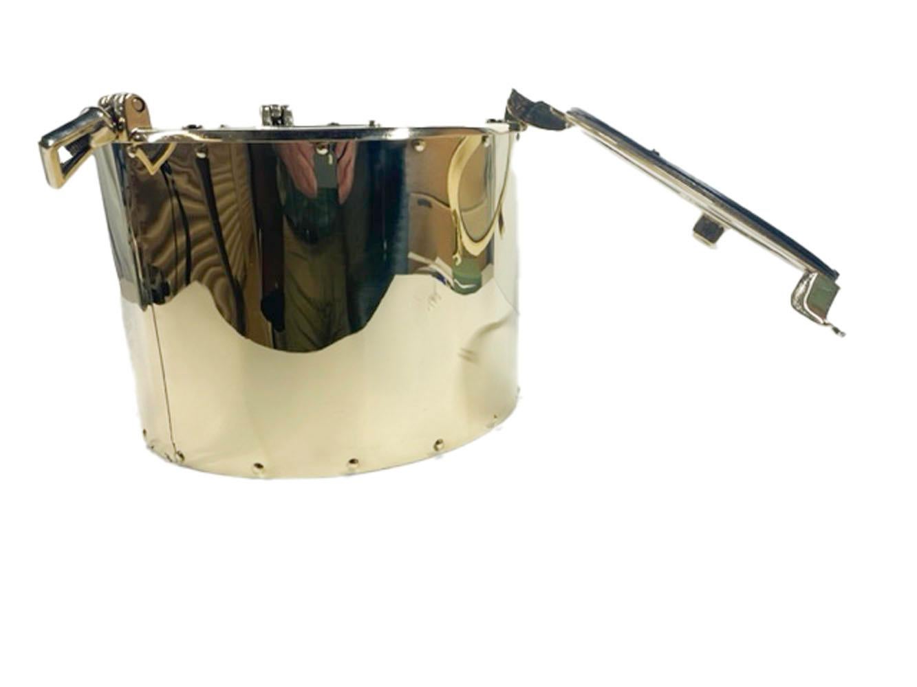 Vintage brass ice bucket of cylindrical form with a hinged ship's porthole cover, having a glass window and working screw latches enclosing a removable zinc liner.