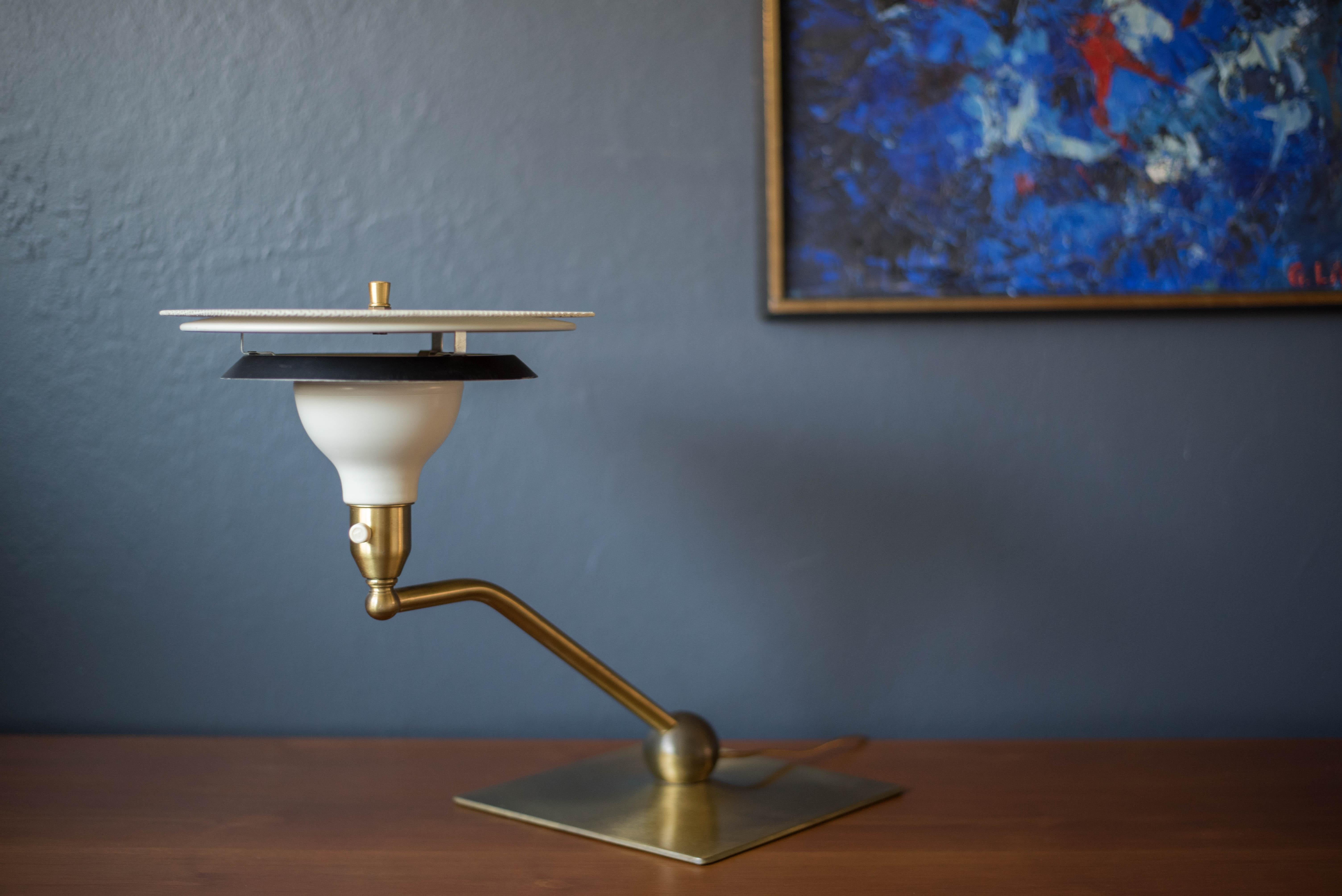 Vintage sight light desk lamp manufactured by M.G. Wheeler Company, circa 1960's. Features a rotating swivel arm and supporting base in brass. Complete with a space age black and white contrasting shade including a perforated metal diffuser. Perfect