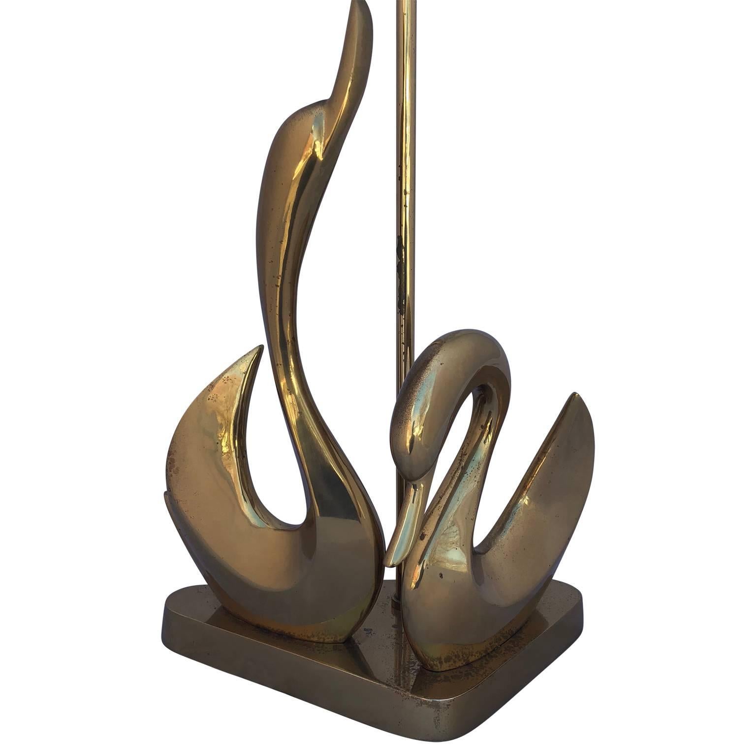 Mid-Century Modern brass swan desk lamp on a triangular base.