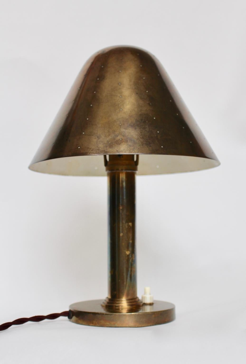 We present a very rare table lamp, bedside Lamp or wall light designed by Carl-Axel Acking attributed, Sweden, 1940s.
The table lamp or sconce was made of brass with a perforated shade.
Furthermore, the table lamp features a movable lamp shade. So