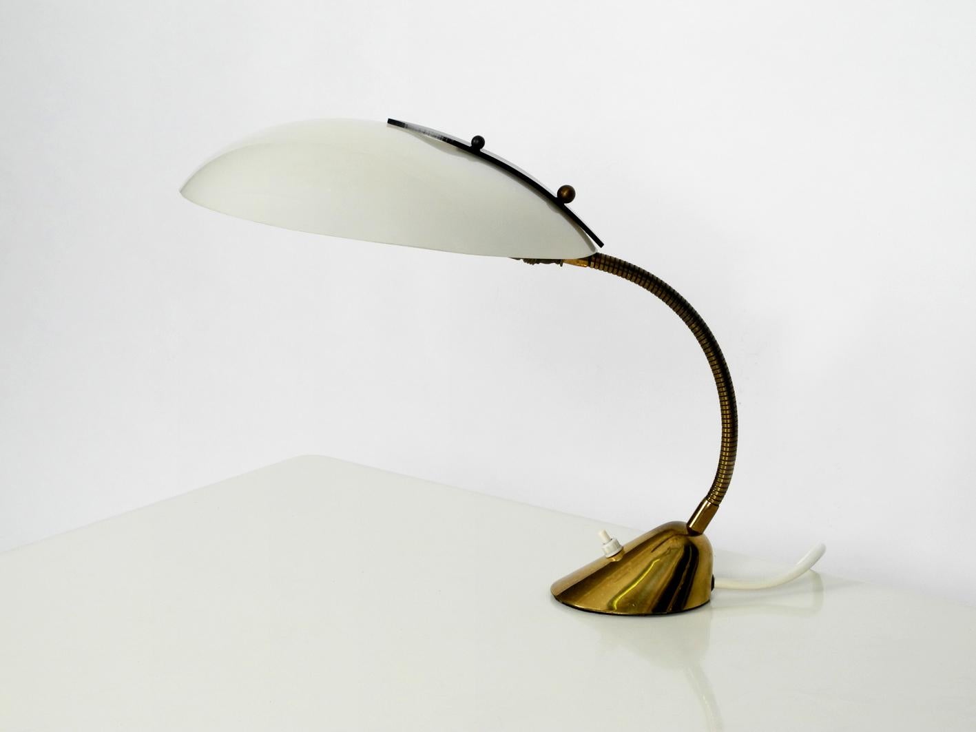 Very rare Mid-Century Modern brass table lamp with plexiglass shade. The freely movable neck and foot are made of brass. Ideal as a reading and desk lamp. Nice light also through the slightly transparent shade.
Very nice condition without damage