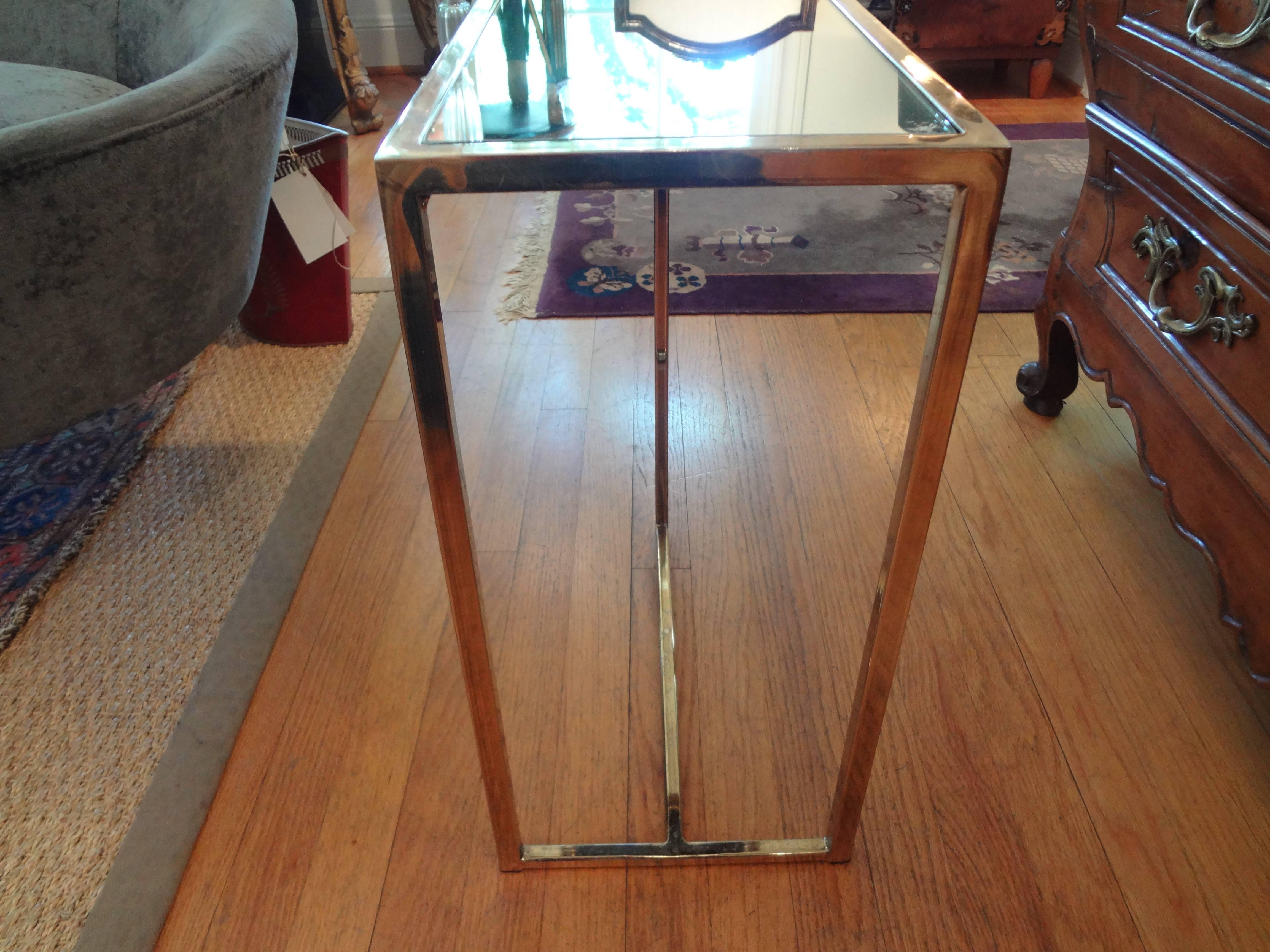 Unusually shaped Mid-Century Modern Milo Baughman inspired brass table with a mirrored top, circa 1970.
