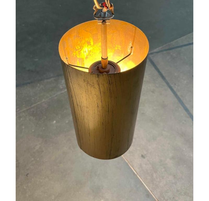 Former church lamp from the 60s.

A functional design of simple elegance. The lamp body is formed by a tube made of brass. The material has a wonderfully dark patina. Inside is the socket element on which the reflector tube rests. The light
